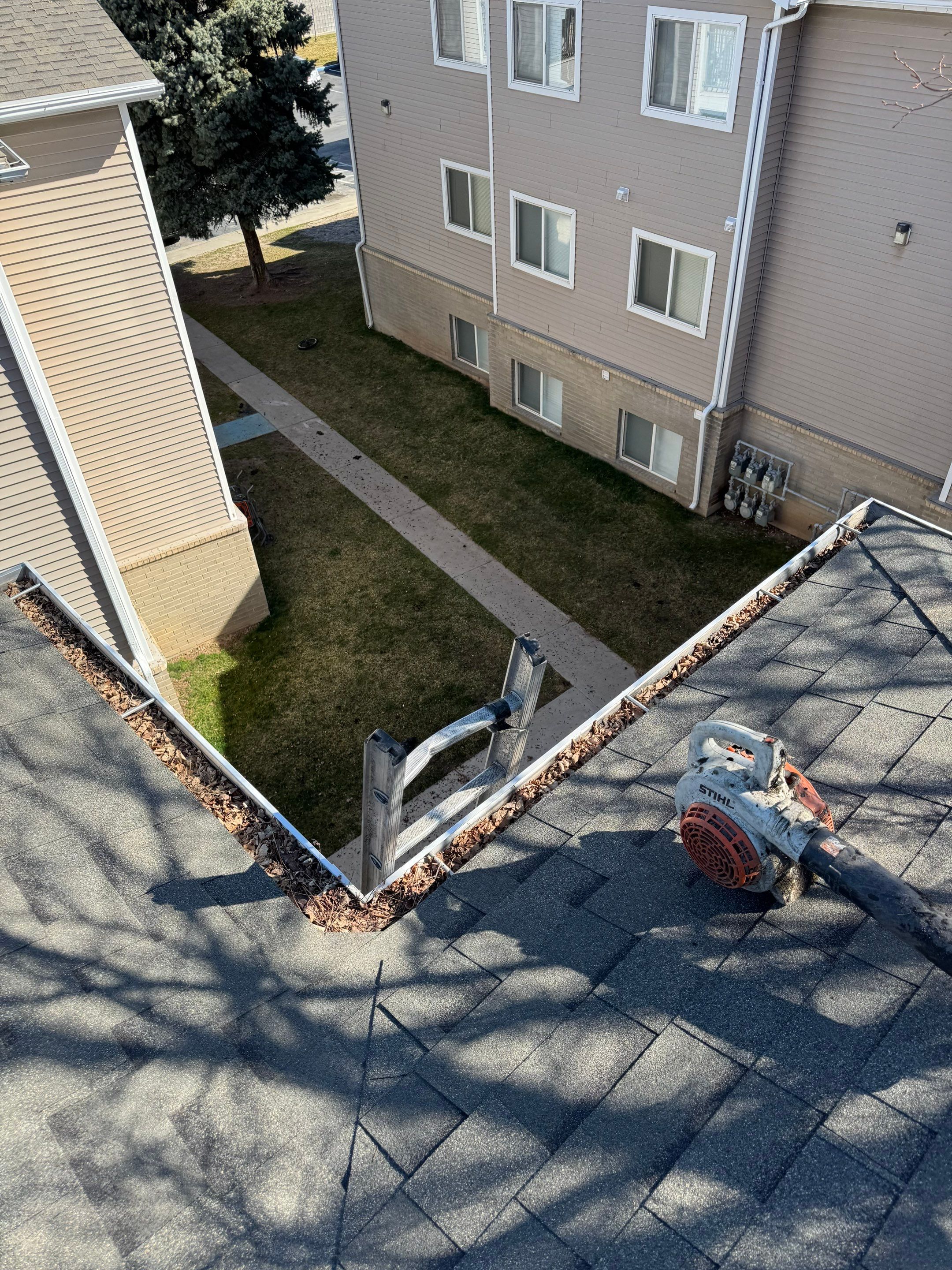 Commercial gutter cleaning Salt Lake City before photo with filled gutters