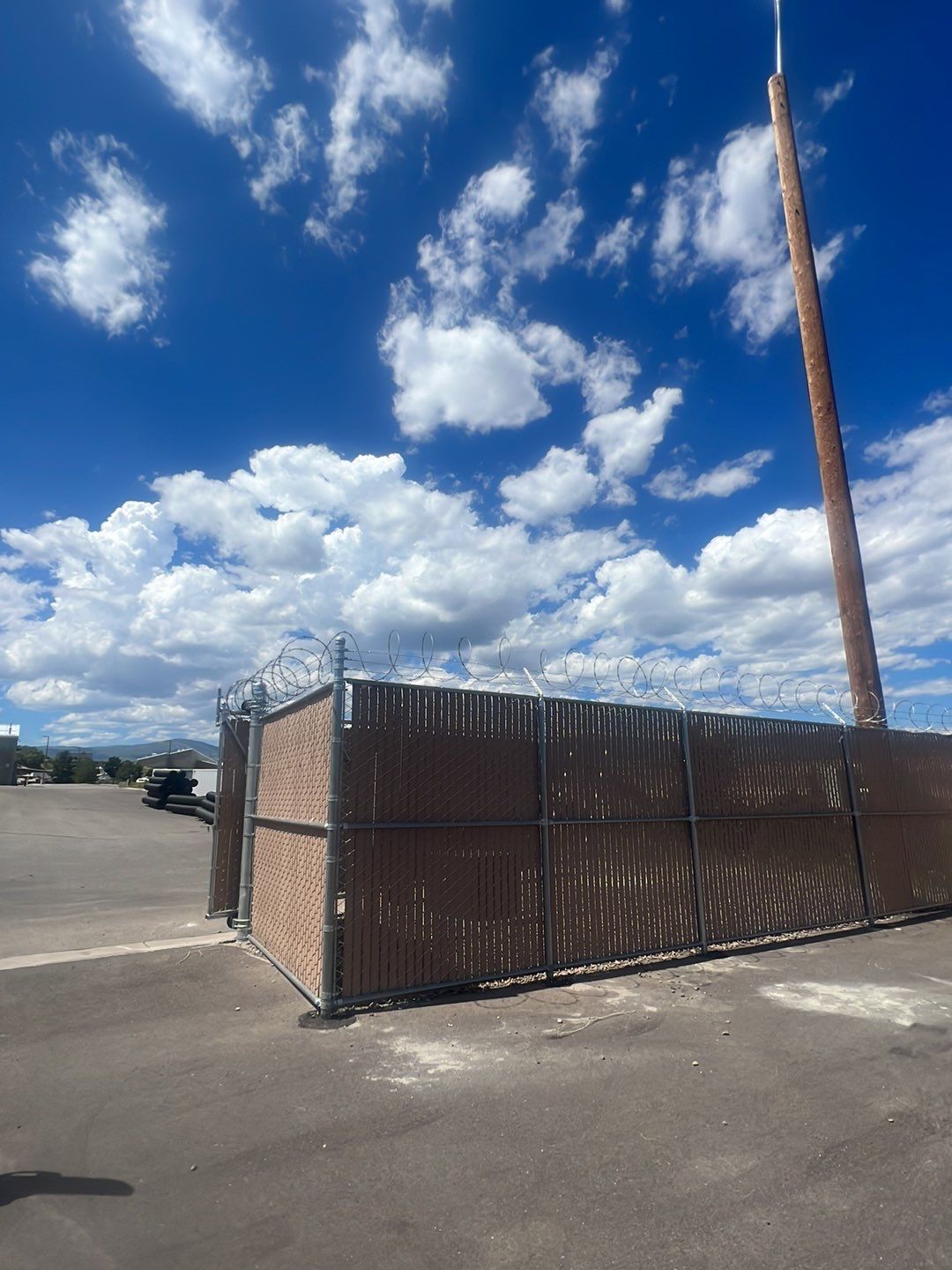 Commercial       using 8'+1' 9ga chain link with slats and razor wire by Valley Fence Company