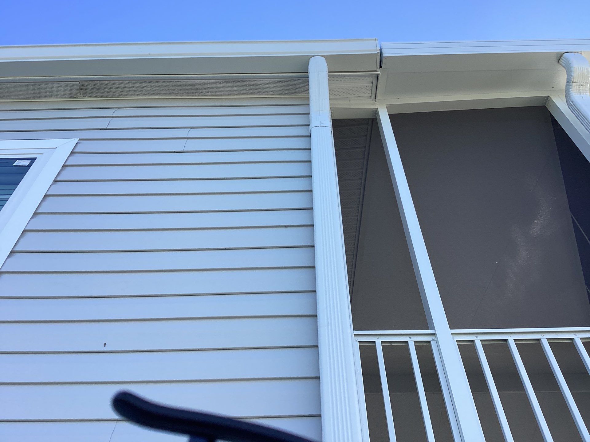 White Downspouts Installation in St. James City by Gutter Professors