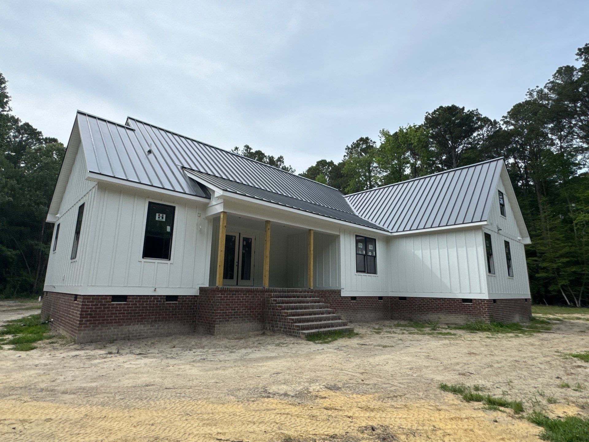 Custom New Construction Home Featuring Standing Seam Metal Roofing in Port Haywood by Cade Construction
