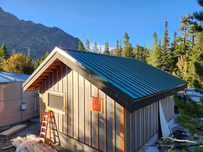 Green Standing Seam Metal Roof Installation in East Glacier Park