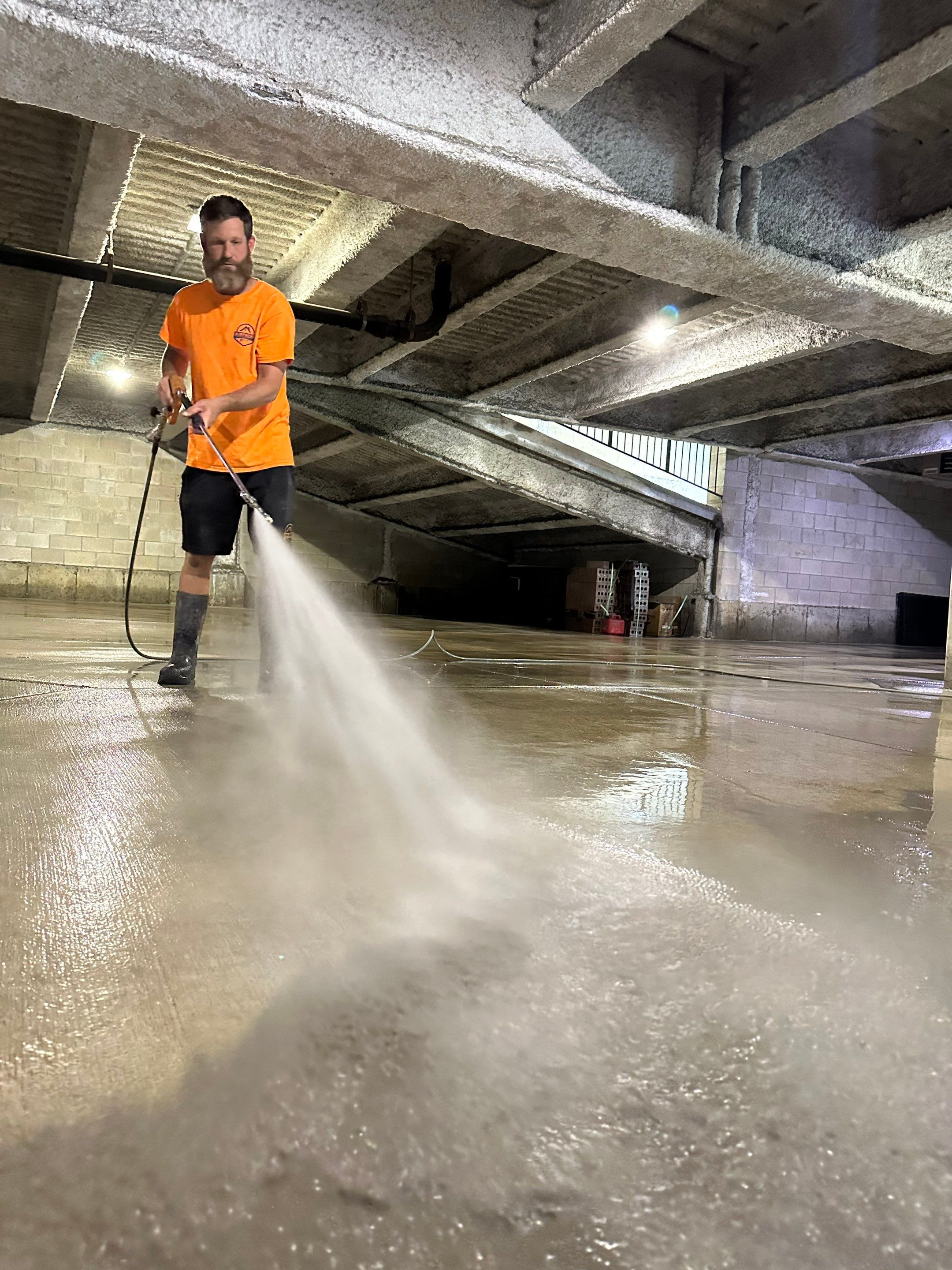 Parking garage using Hot water by Northern Power Washing LLC.