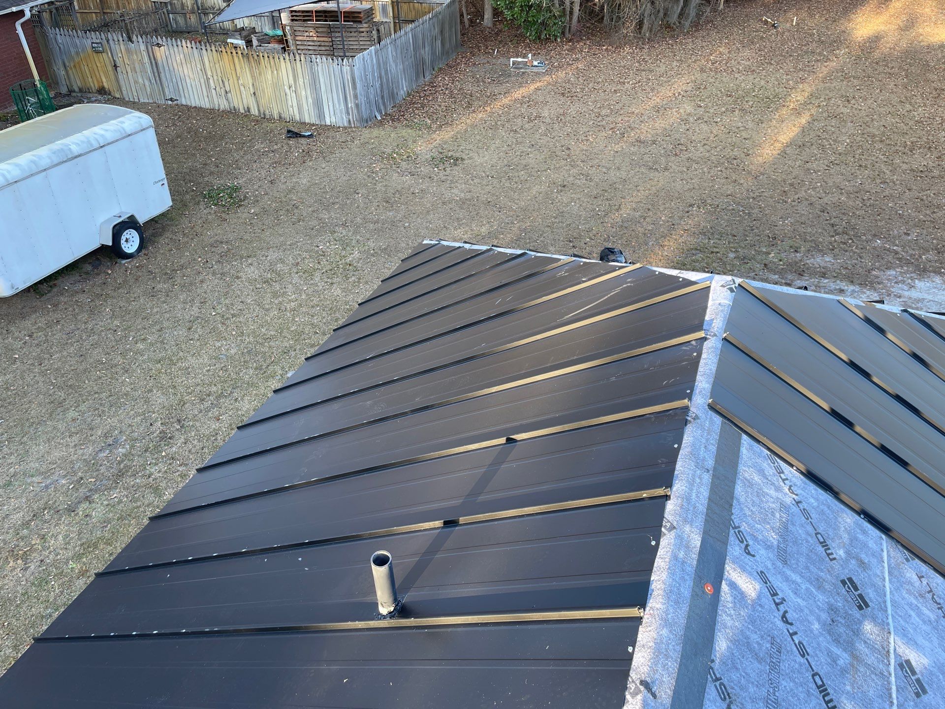 Residential Roofing Installation using Benton 26Ga 1inc Snapcock Metal Roof KYNAR Matte Black by Talya Roofing