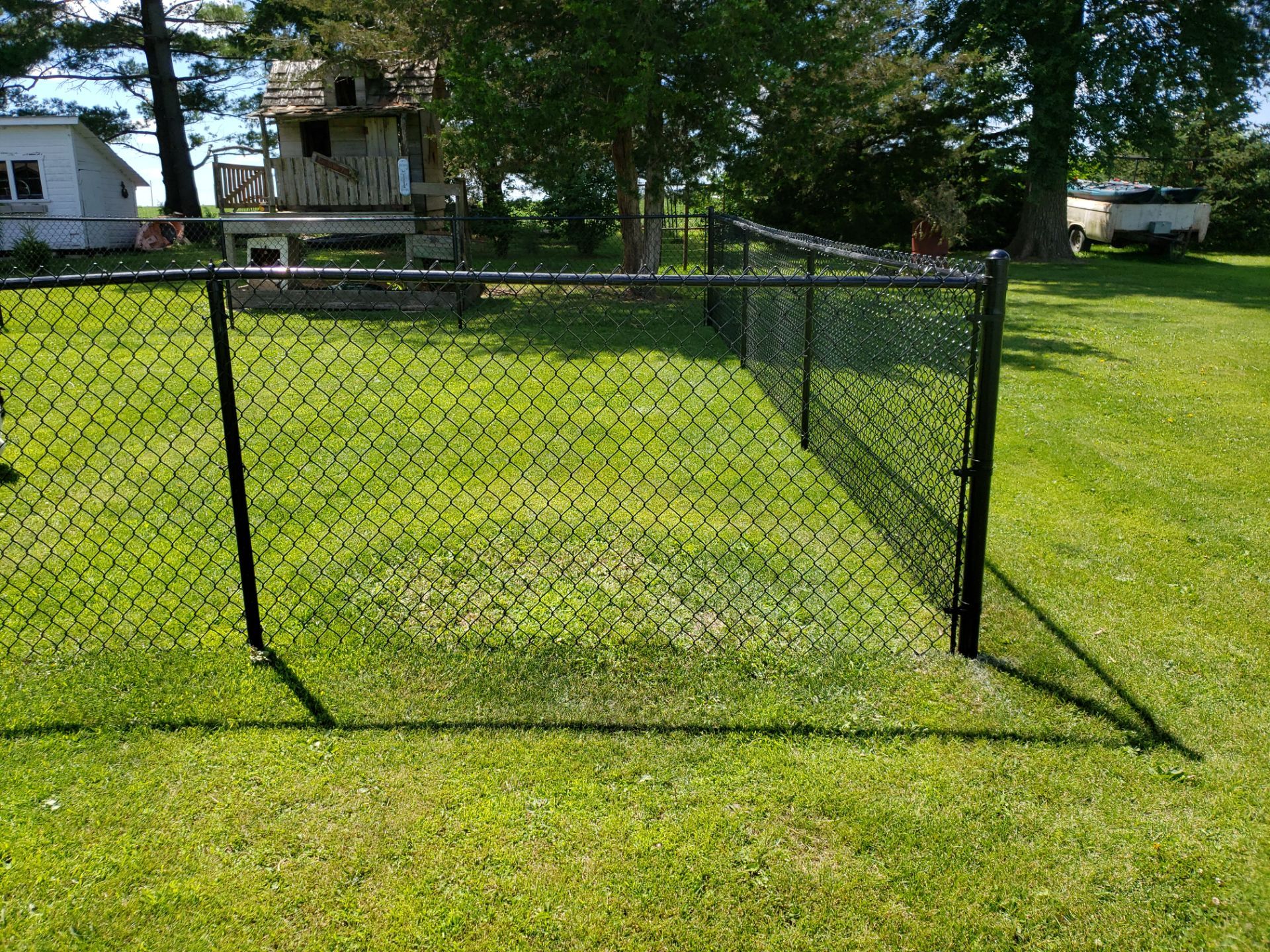 Residential Black Vinyl-Coated Chain Link Fence Installation in Bristow by Perfect Picket Fence and Stain