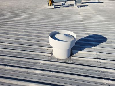 Completed metal roof with white roof vent