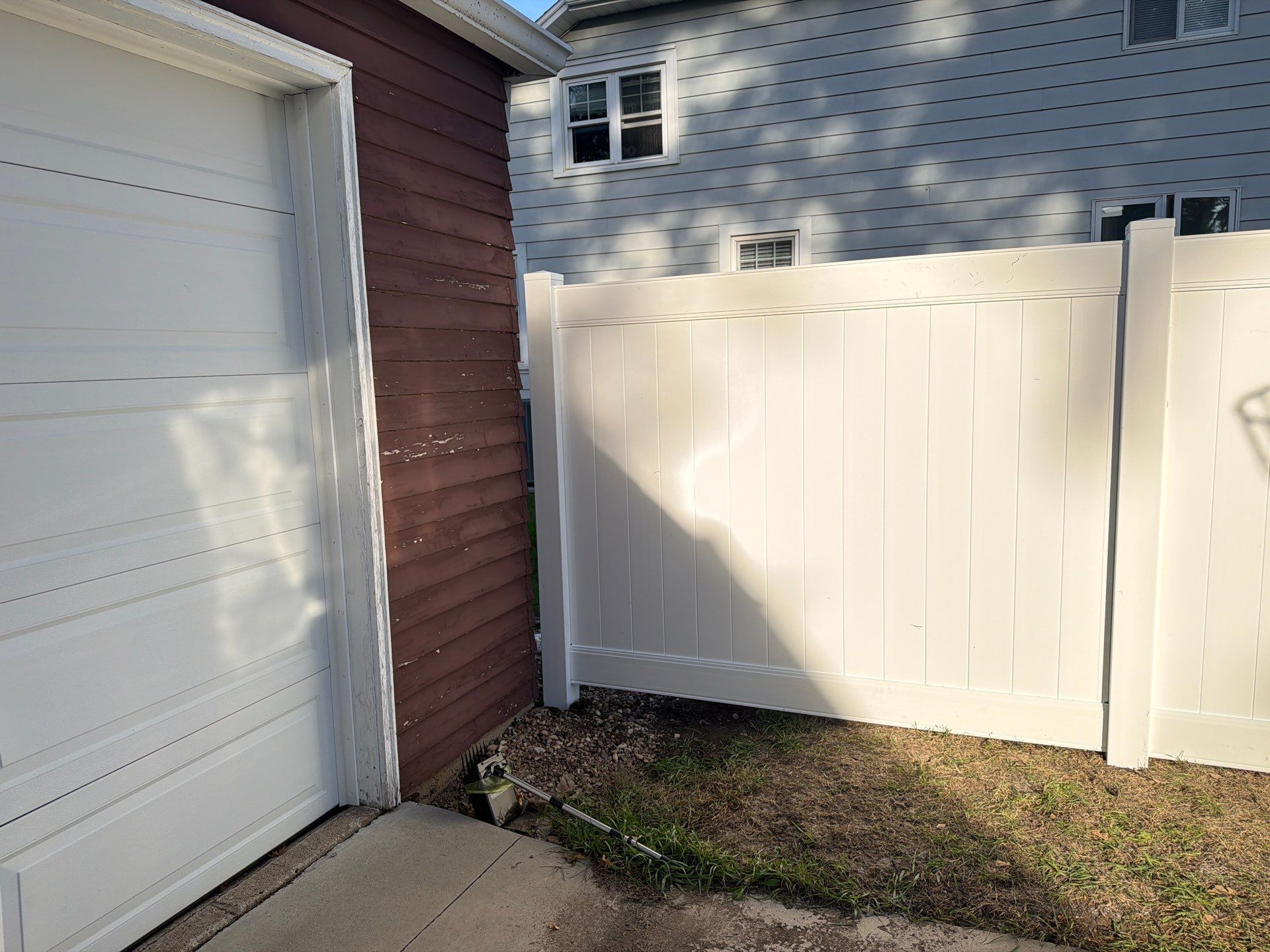 White Vinyl Privacy Fence and Gate Installation in Grundy Center by Perfect Picket Fence and Stain