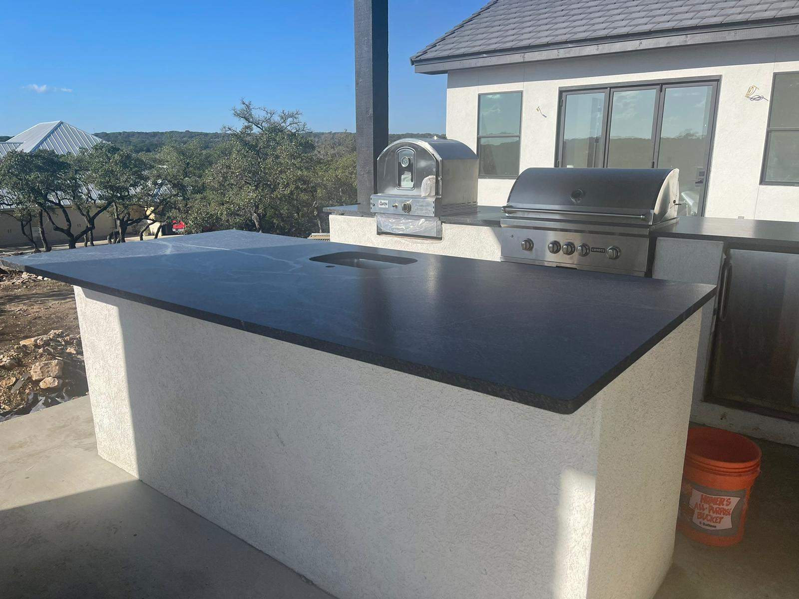 Outdoor kitchen using Black mist honed granite by Mena stone surfaces