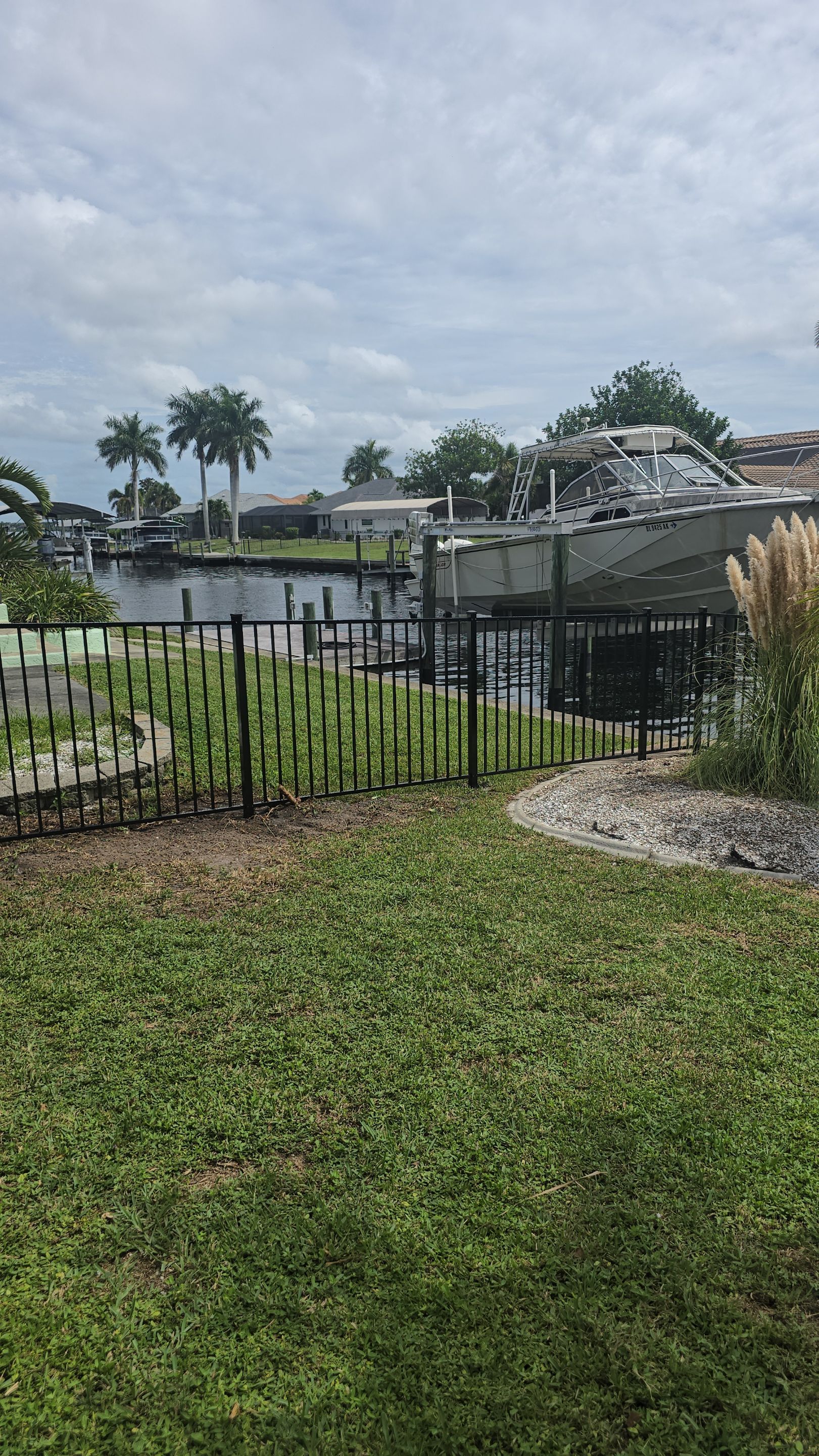 Black Aluminum Picket Fence Installation for Port Charlotte Canal Home by True Fence LLC