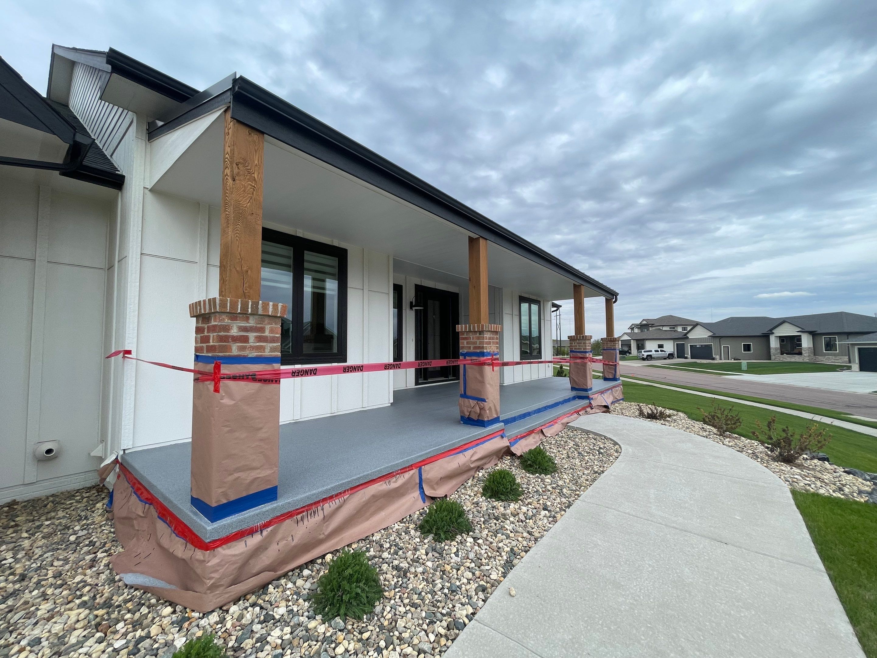 Grey Speckled Concrete Porch Coating for Sioux Falls Home by Select Painting, Coatings & Garage Cabinets