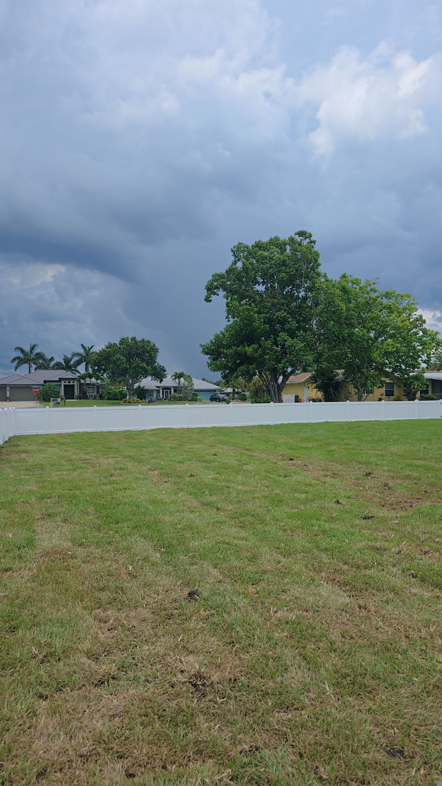 White Vinyl Privacy Fence Installation on Port Charlotte Corner Lot by True Fence LLC