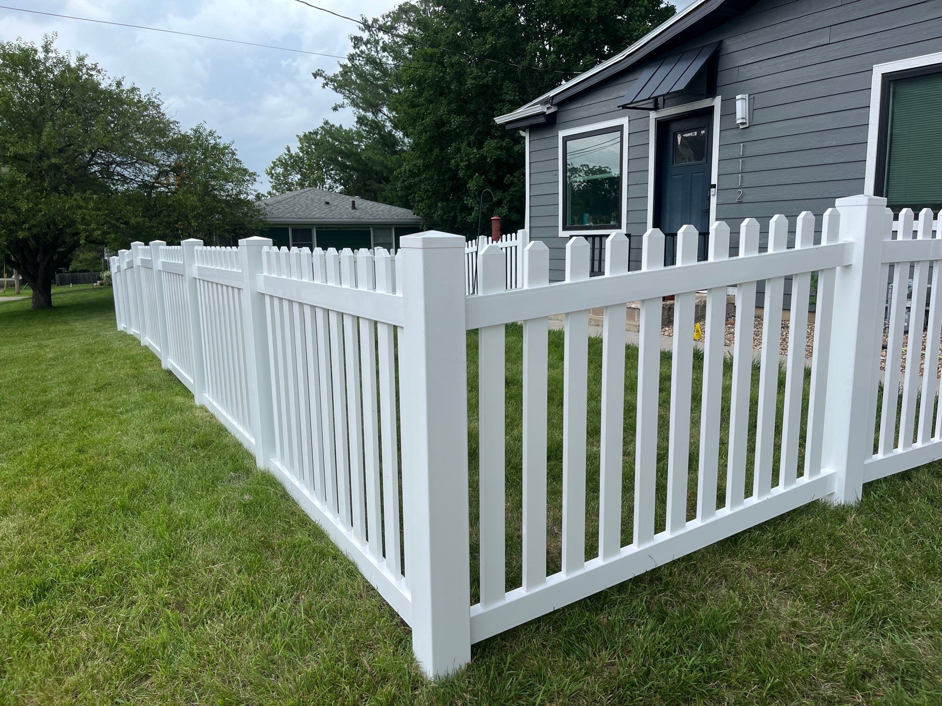 White Vinyl Spaced Picket Fence Installation in Cedar Falls by Perfect Picket Fence and Stain