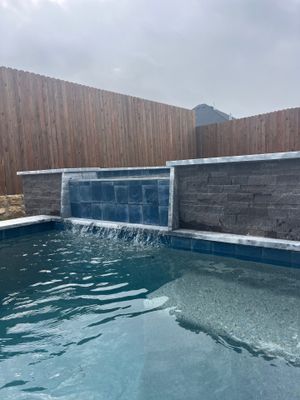 Geometric Pool with Raised Spa and Sheer Descent Waterfall