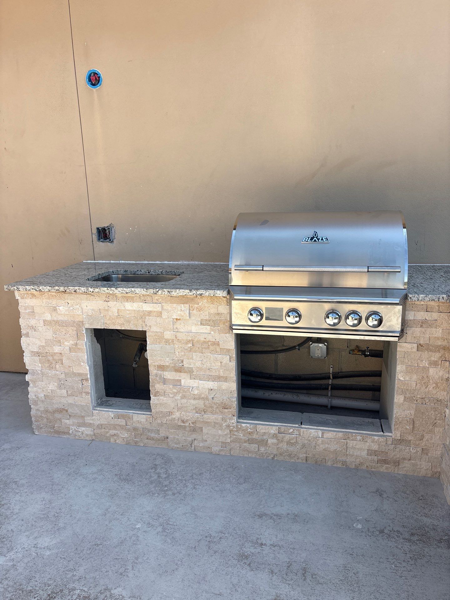 Custom Outdoor Kitchen and Stacked Stone Island in Helotes by Mena stone surfaces