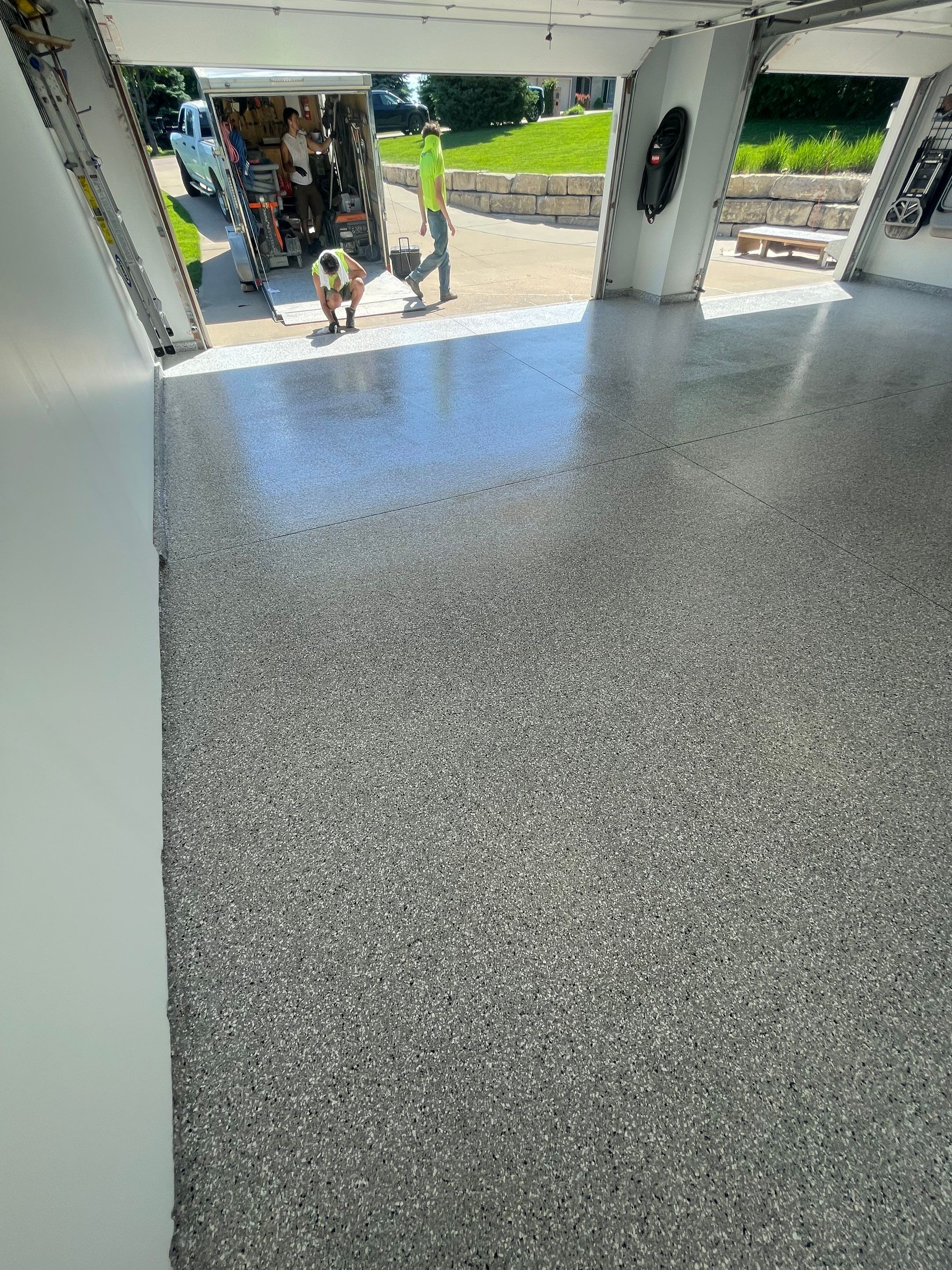 Feather Grey Garage Floor Coating Installation in Sioux Falls by Select Painting, Coatings & Garage Cabinets