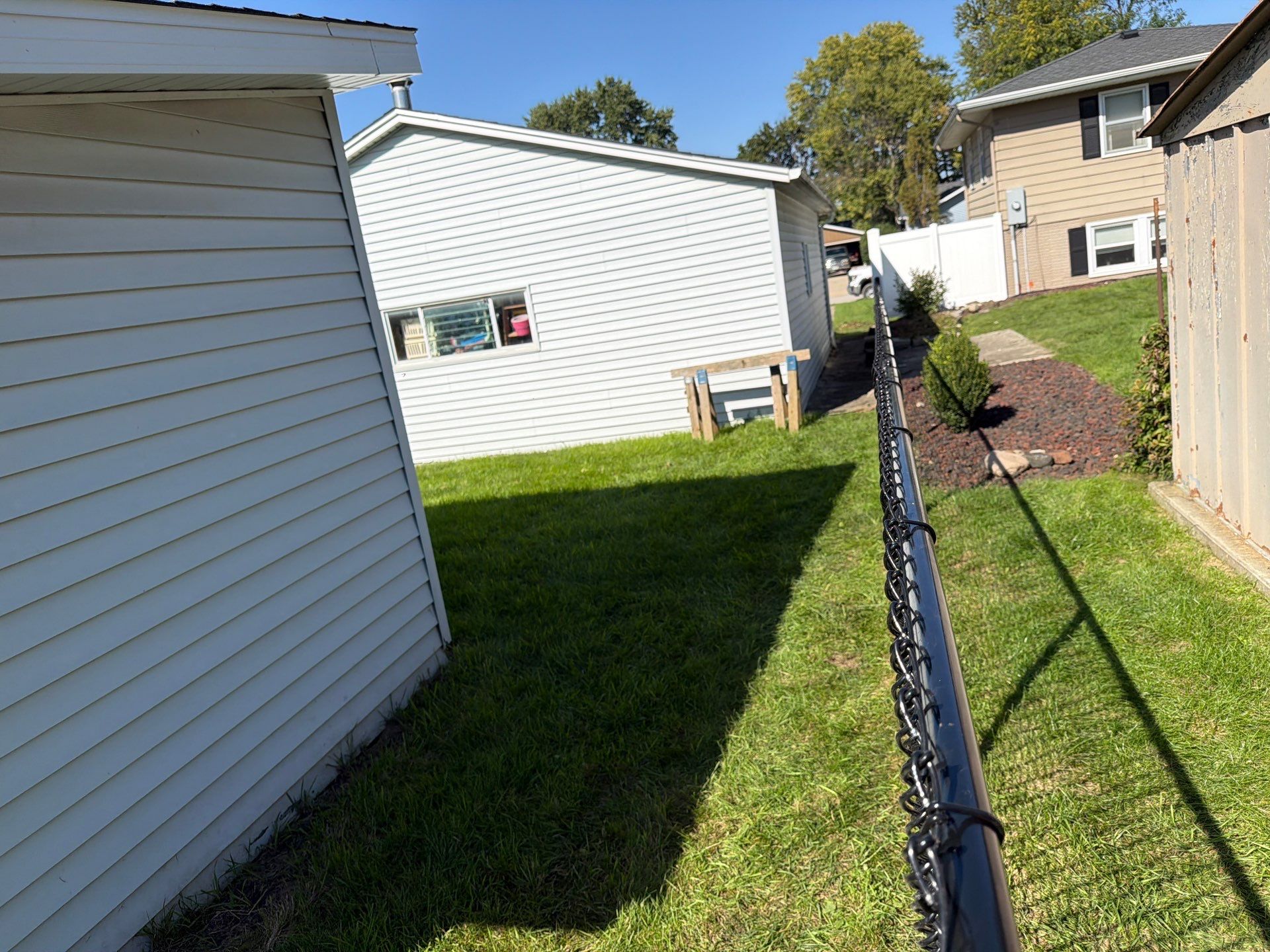 Custom Vinyl Privacy and Black Chain Link Fence Installation in Cedar Falls by Perfect Picket Fence and Stain