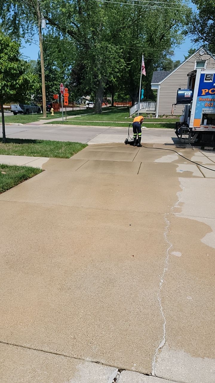 Oil extraction from concrete driveway.  by Northern Power Washing LLC.