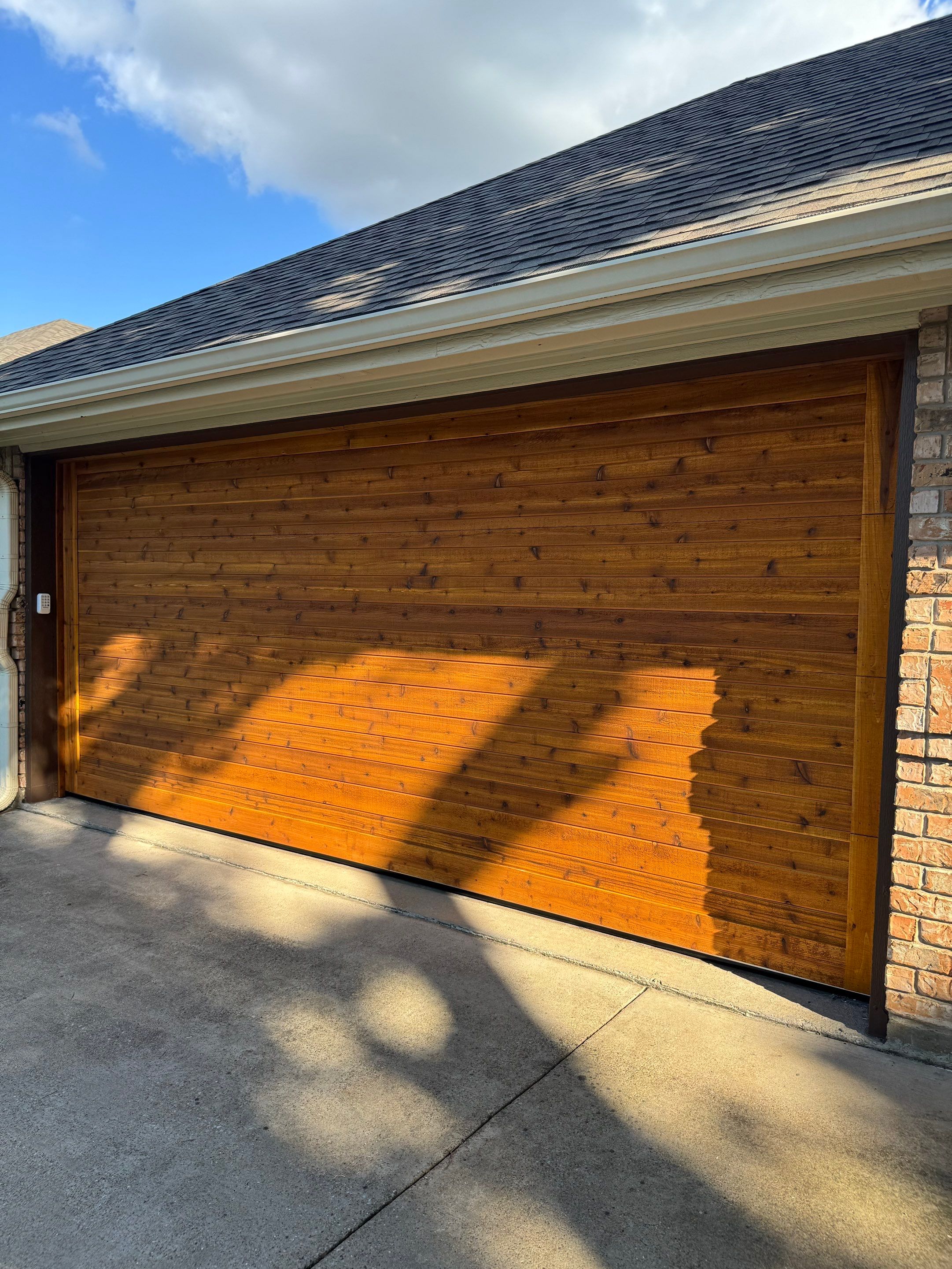 Custom Stained Cedar Garage Door Installation in Grapevine by Meadows Garage Doors