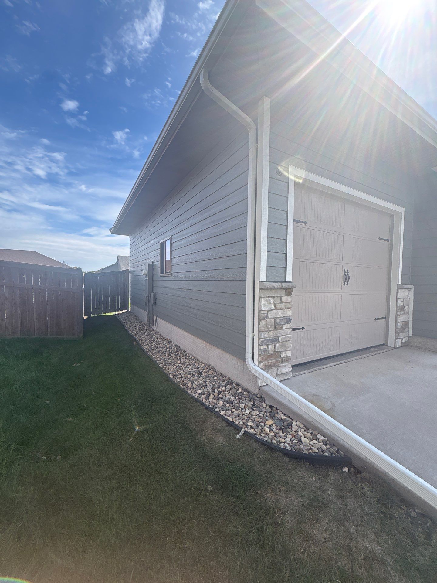 Full Exterior Home Painting on Blue Lap Siding in Sioux Falls by Select Painting, Coatings & Garage Cabinets
