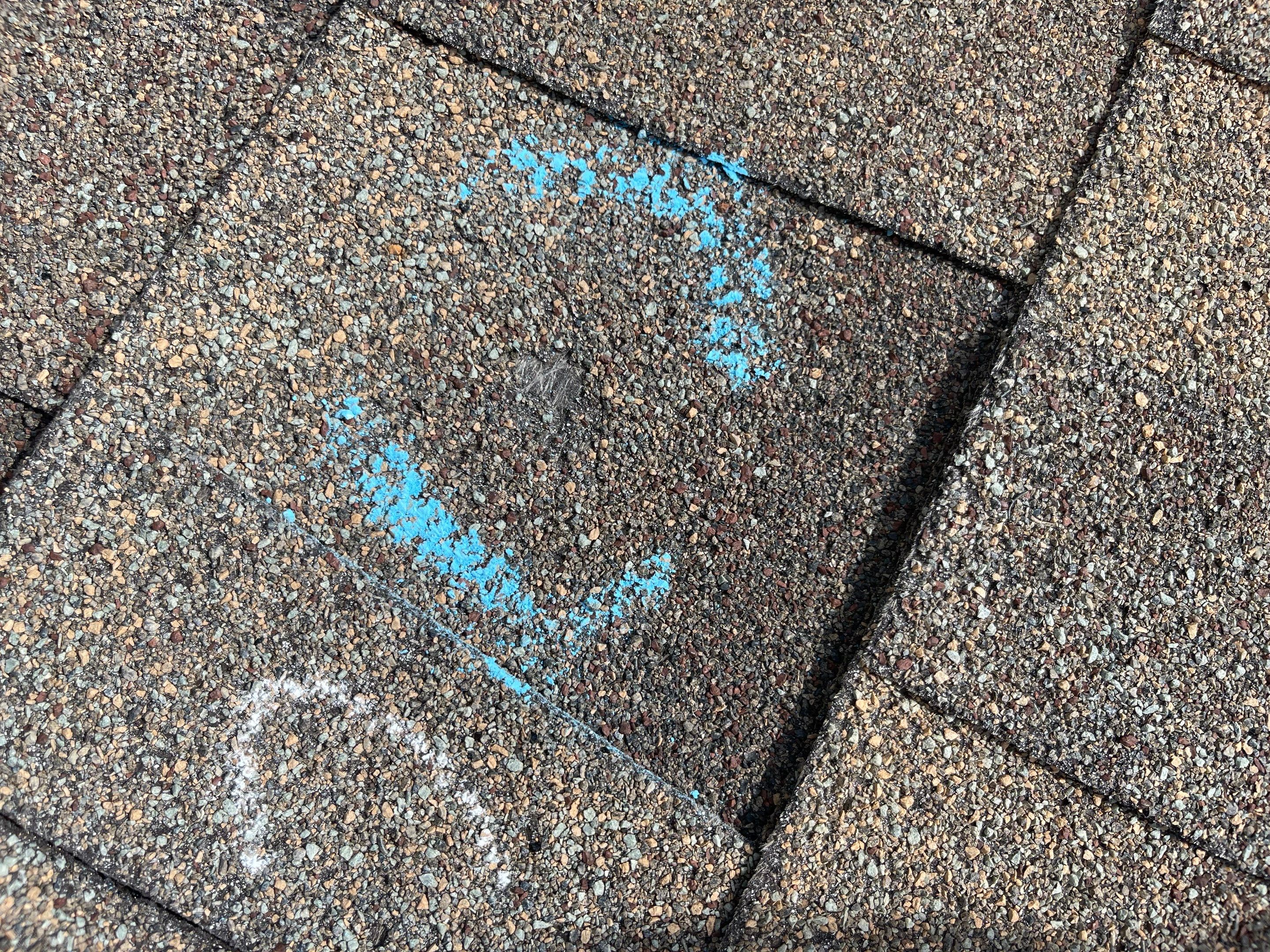 Hail Damage on a Roofing System by Icon Roofing And Construction 
