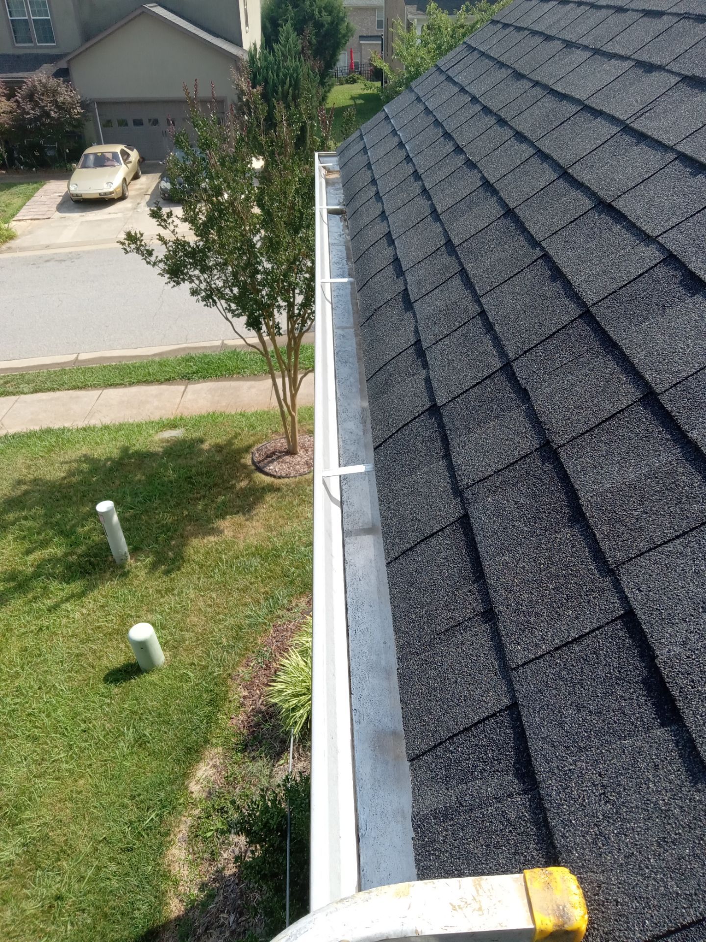 pressure washing gutters and downspouts removing debris and stains restoring appearance