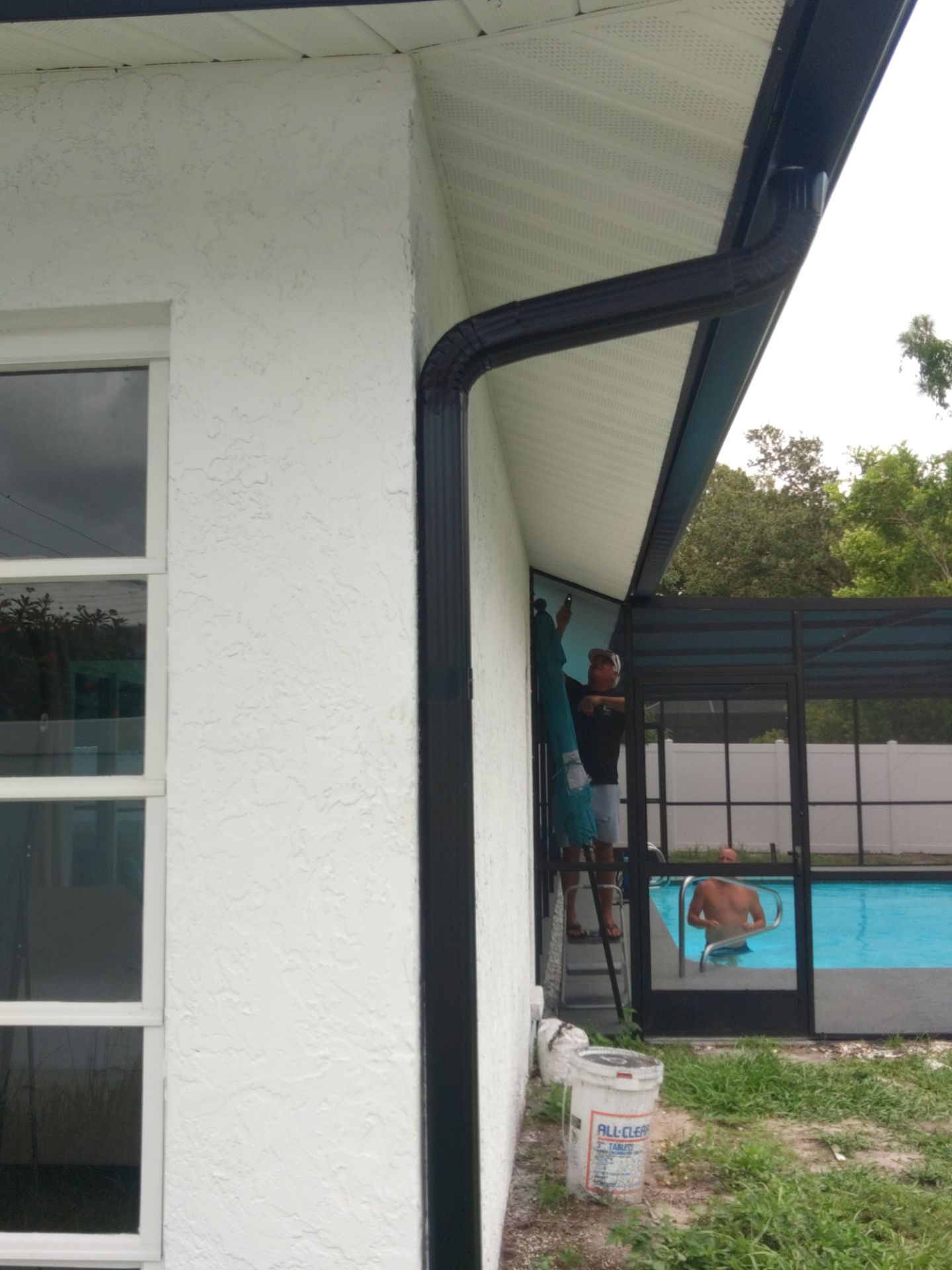 Black seamless gutters and downspouts installation in Sarasota, FL by Gutter Professors