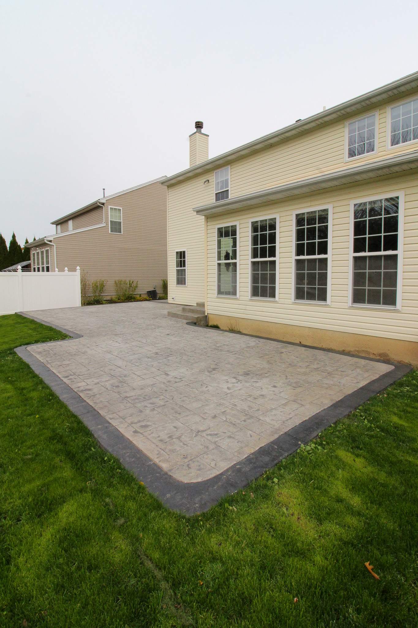 Stamped Concrete, Entry Door, and Concrete  by Ivy Lea Construction