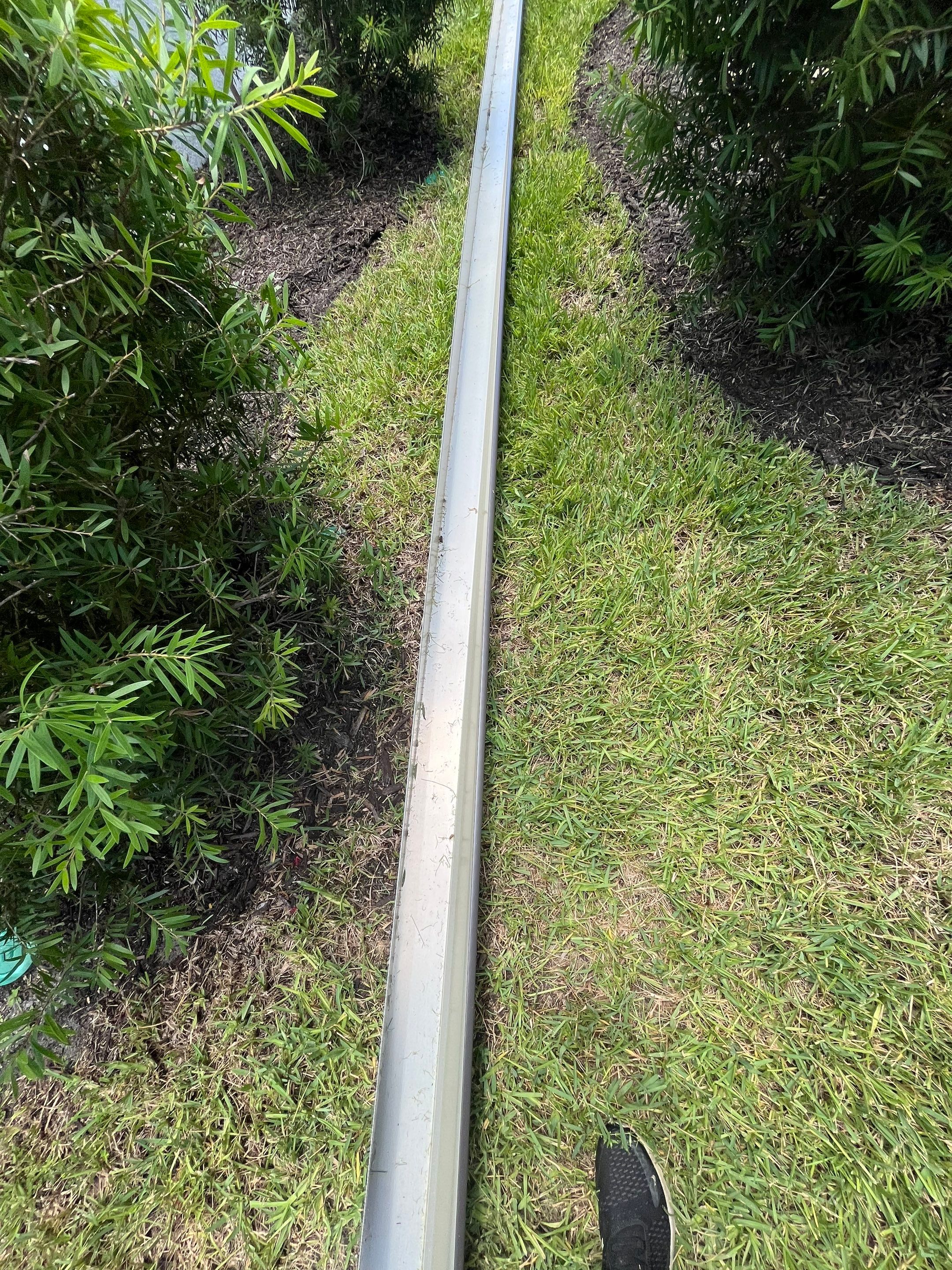 Dark Bronze Gutters and White Downspouts in Sarasota FL by Gutter Professors