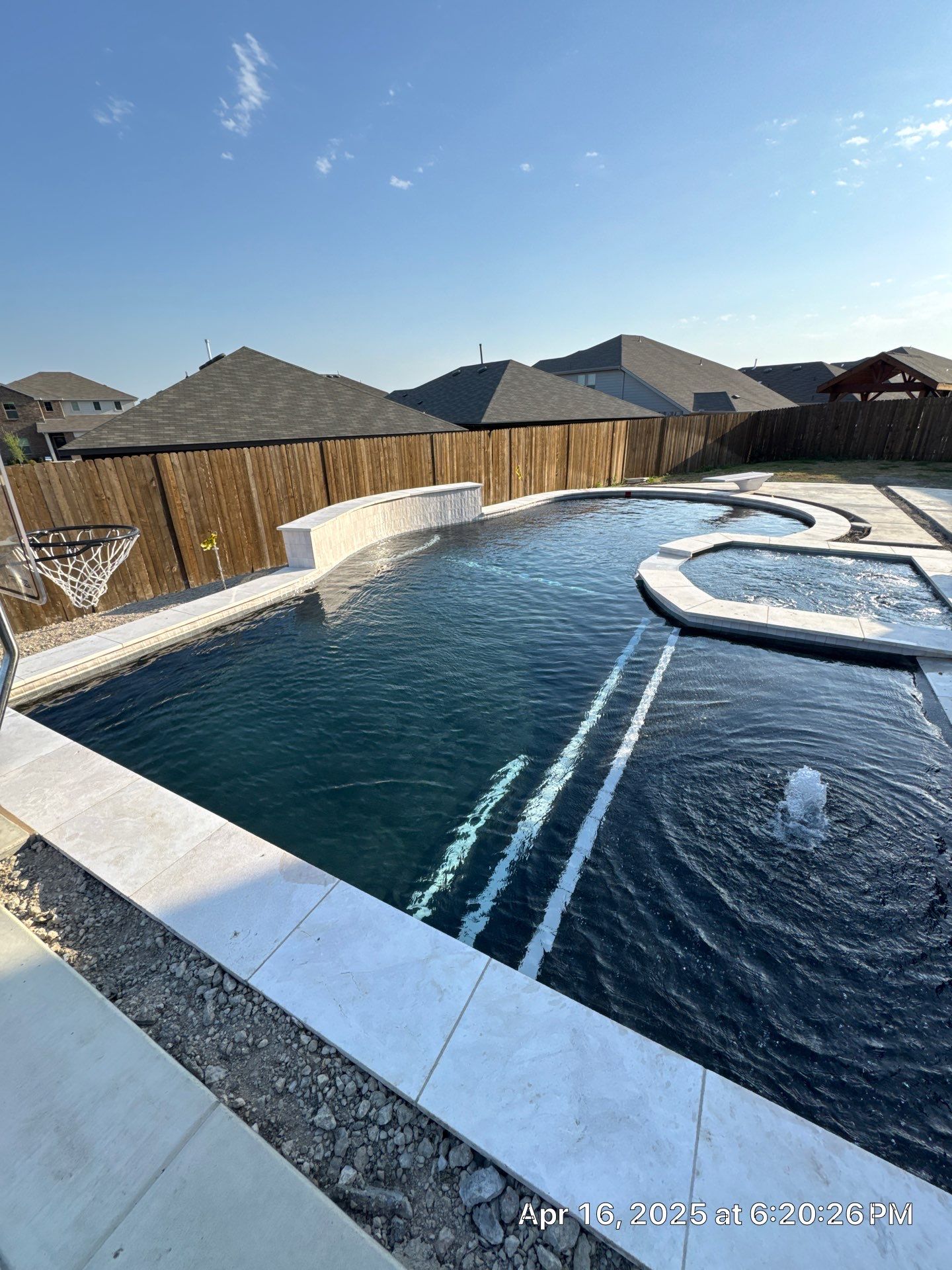 Geometric Pool with Spillover Spa and Dark Interior by Pinnacle Pools and Spas - DFW
