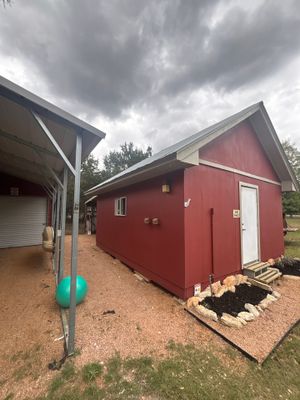 Exterior view of red building with metal roof