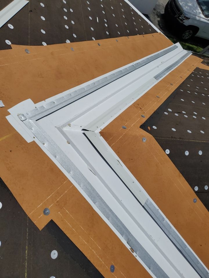 Residential Roofing Installation using 1.5" Nail Strip 24ga Solar White Kynar Coated Standing Seam Metal Panels by Morton Roofing, Inc.