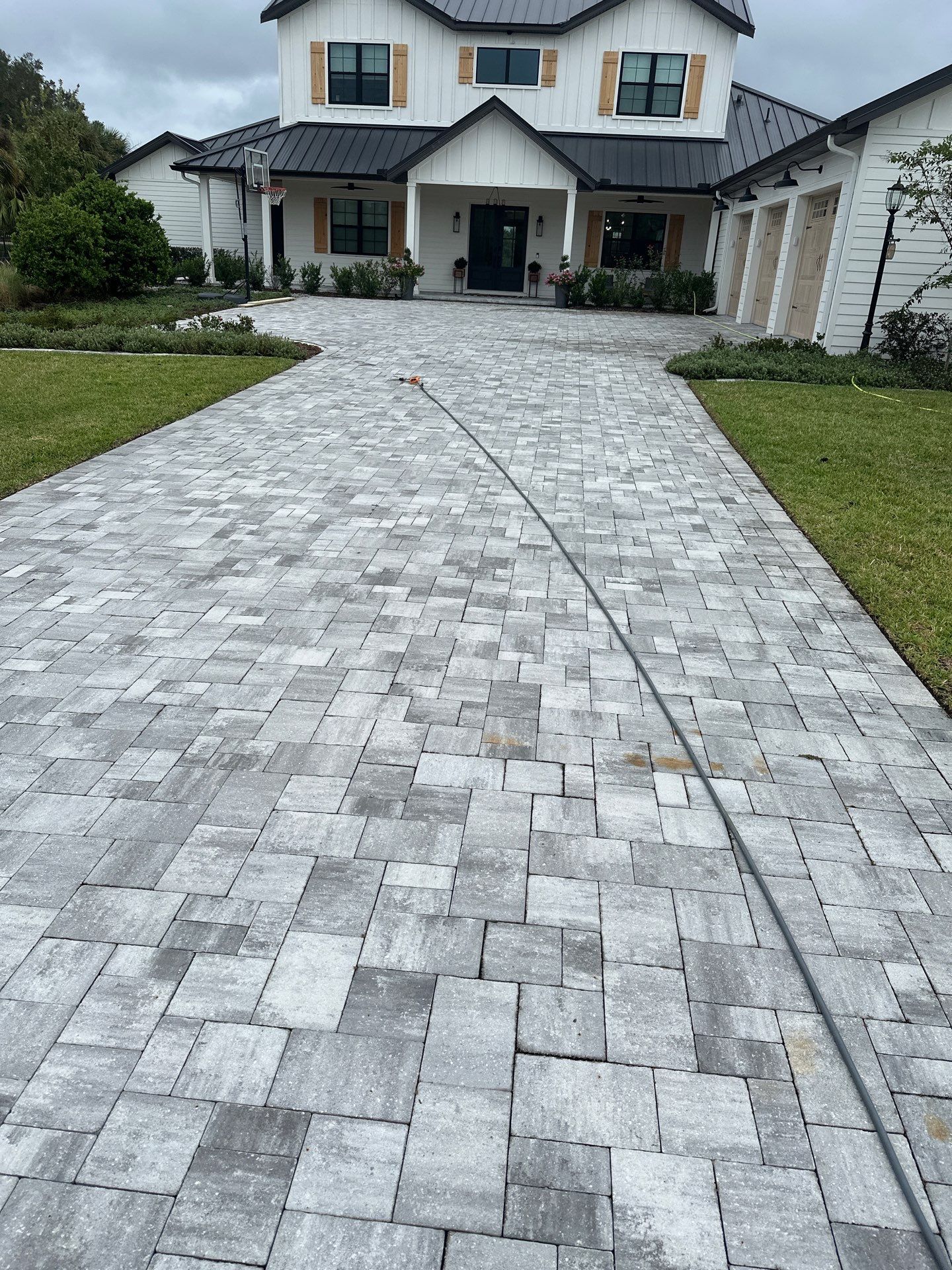Complete Two-Story House Wash and Driveway Cleaning in Winding River Community, Bradenton, FL by Sunshine AquaWash