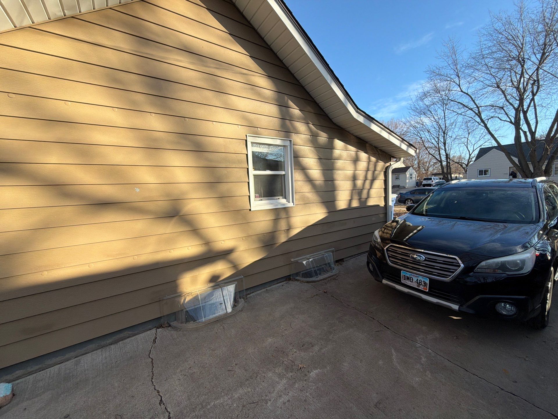 Exterior Siding Repair and Full House Repaint in Sioux Falls by Select Painting, Coatings & Garage Cabinets
