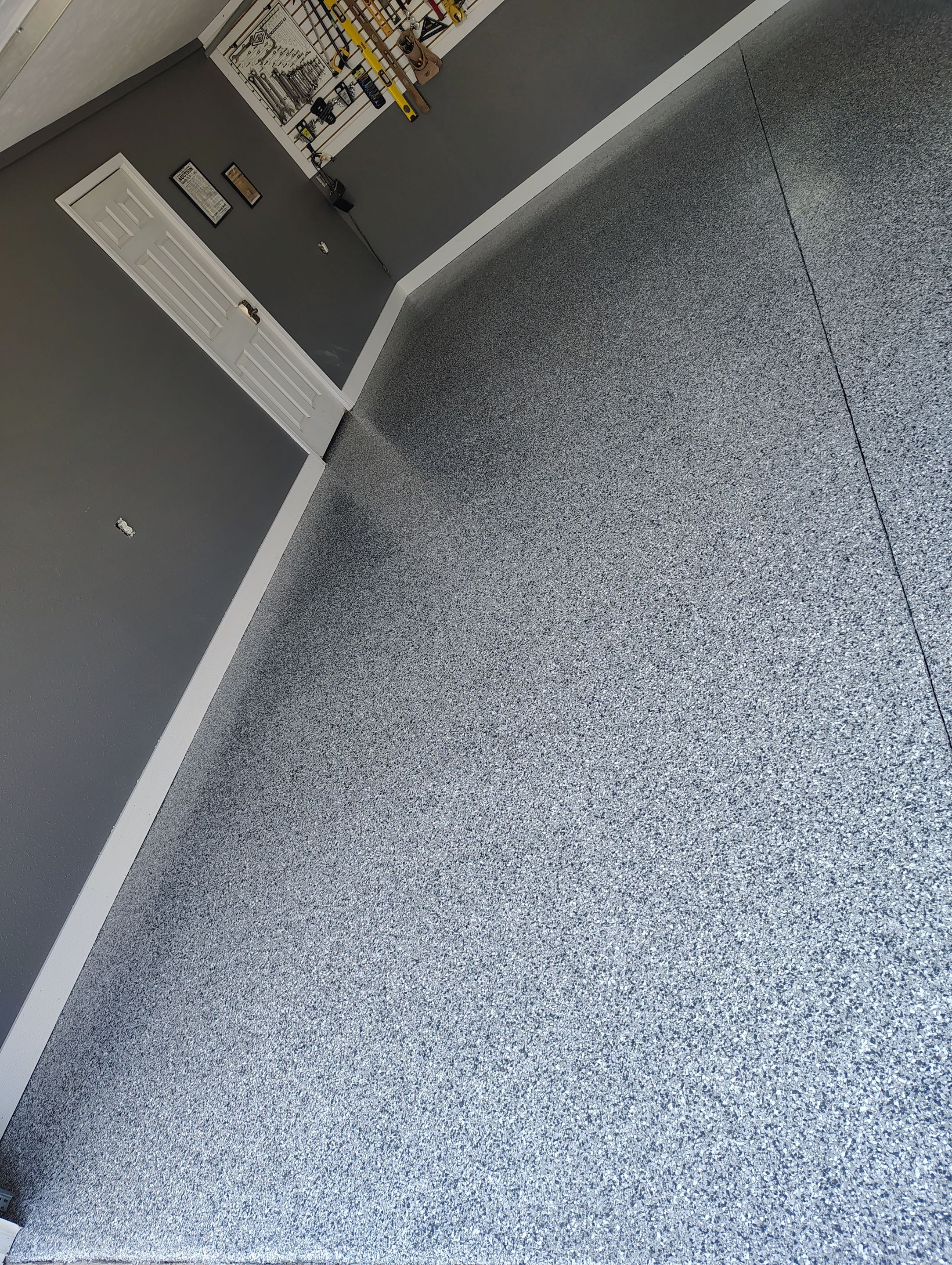 Custom Garage Floor Coating and Backyard Patio Refinishing in Tyndall by Select Painting, Coatings & Garage Cabinets