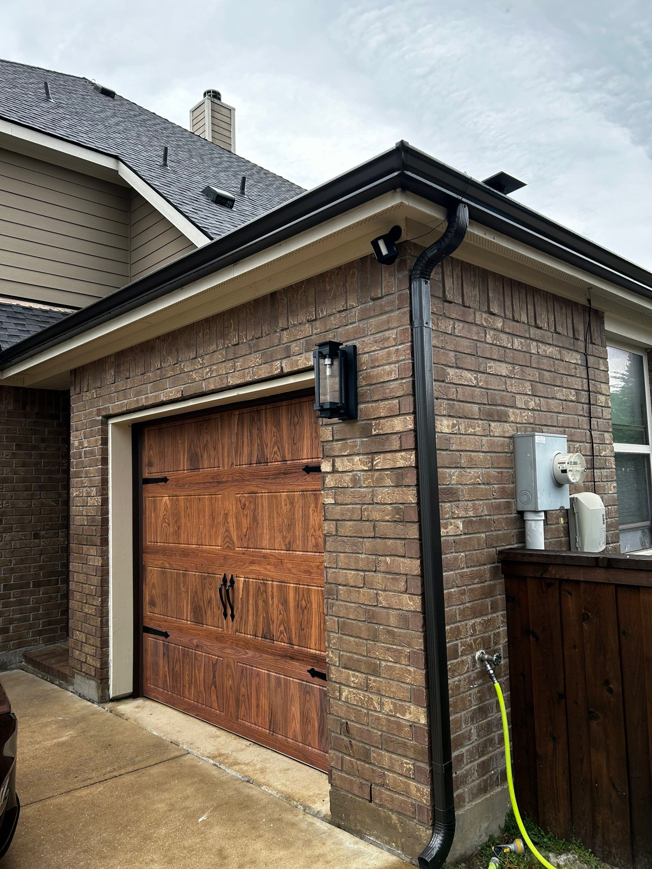 Medium brown brick with GAF Pewter Gray  by Tejas Roofworks + Restoration