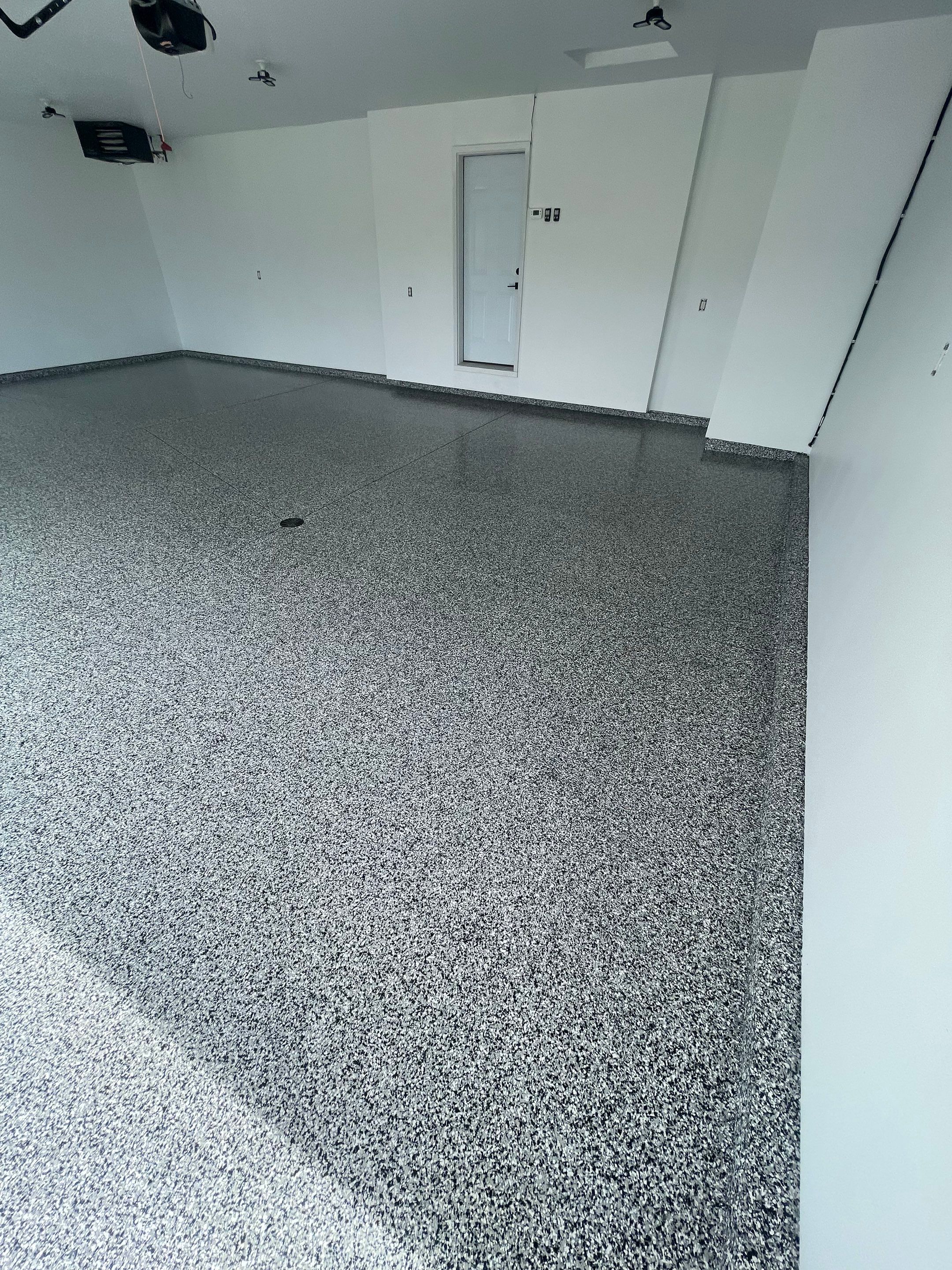 Grey Flake Epoxy Garage Floor Coating in Sioux Falls by Select Painting, Coatings & Garage Cabinets