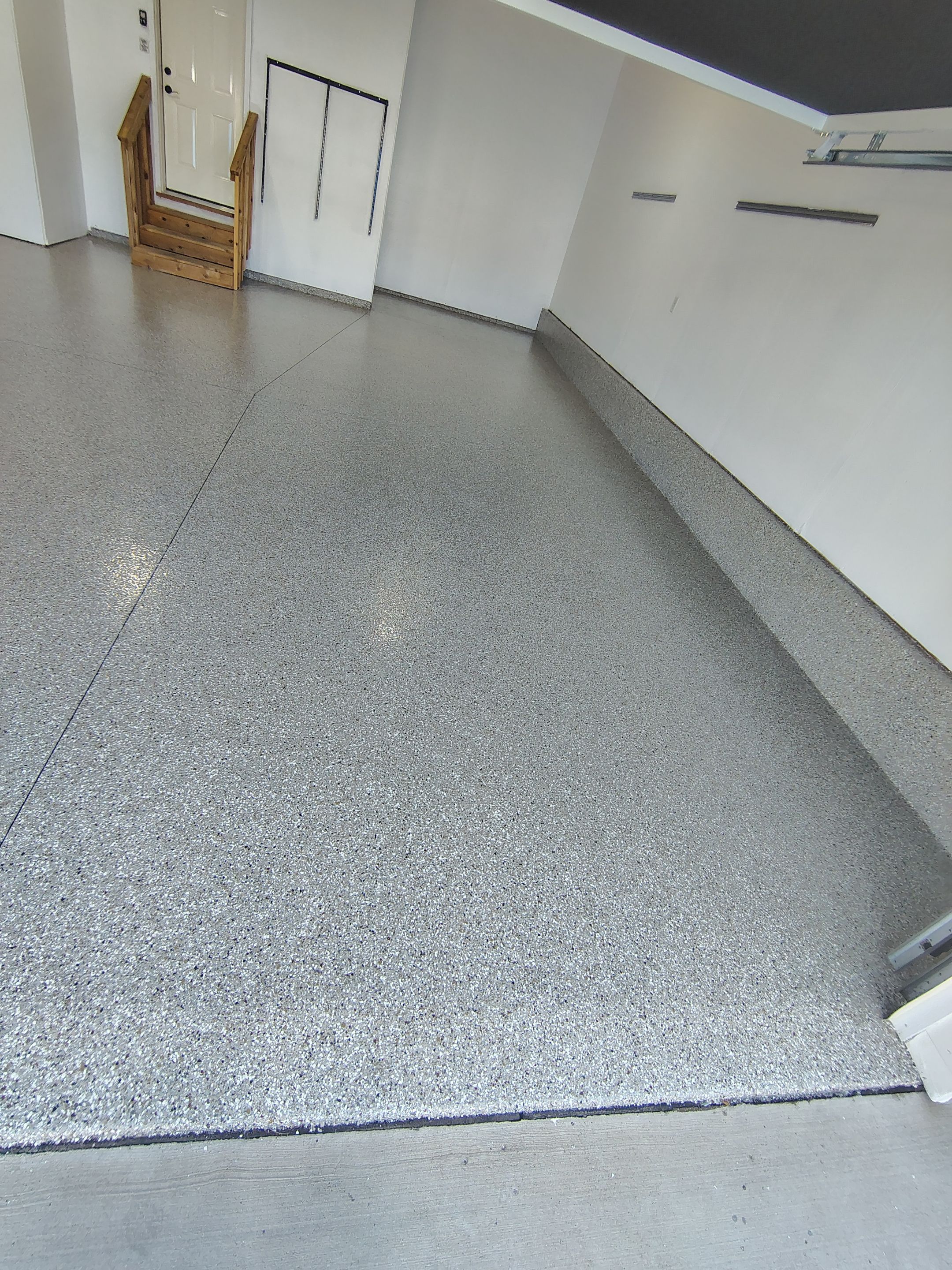 Sioux Falls Garage Floor Transformation With Gray Speckled Epoxy Coating by Select Painting, Coatings & Garage Cabinets