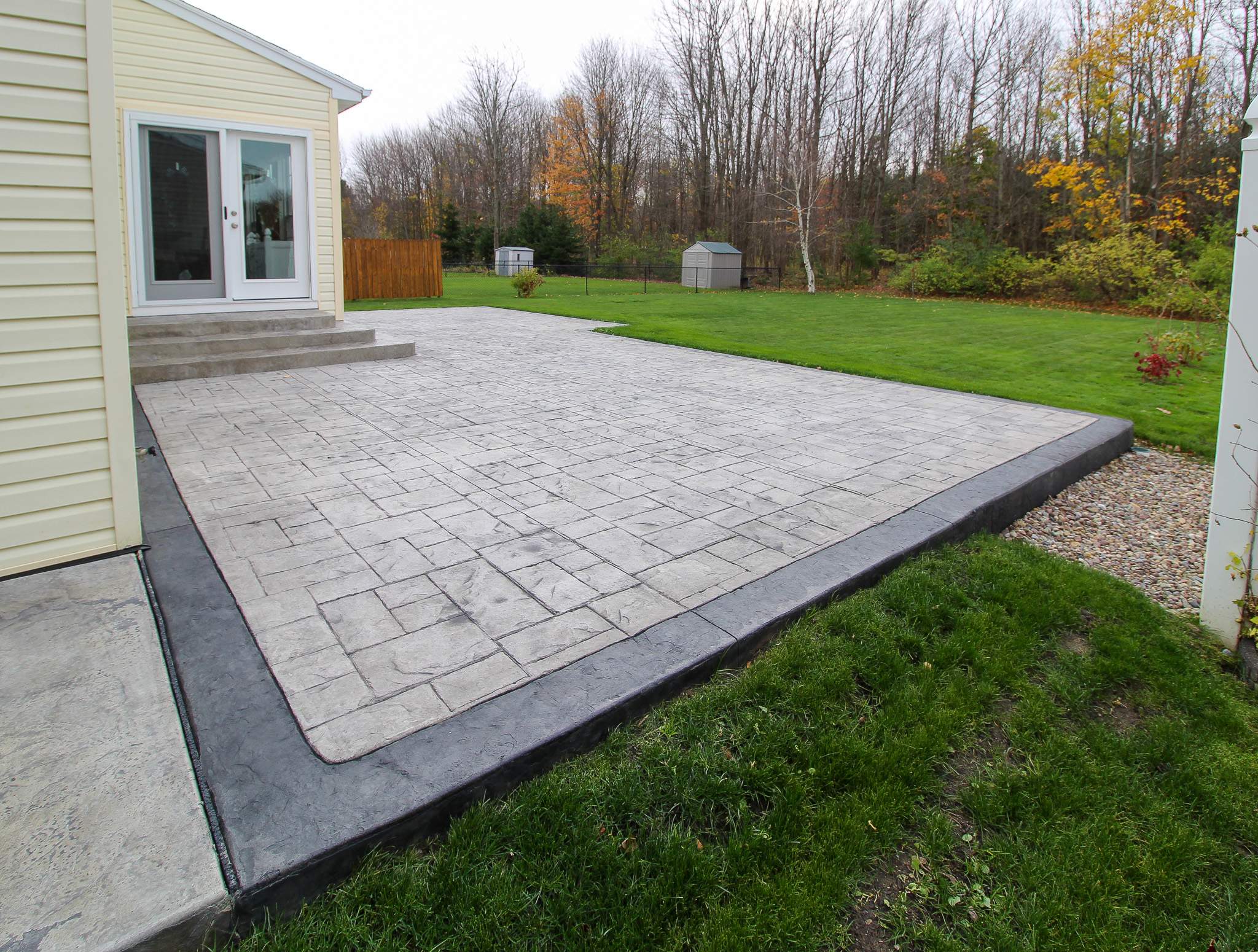 Stamped Concrete, Entry Door, and Concrete  by Ivy Lea Construction