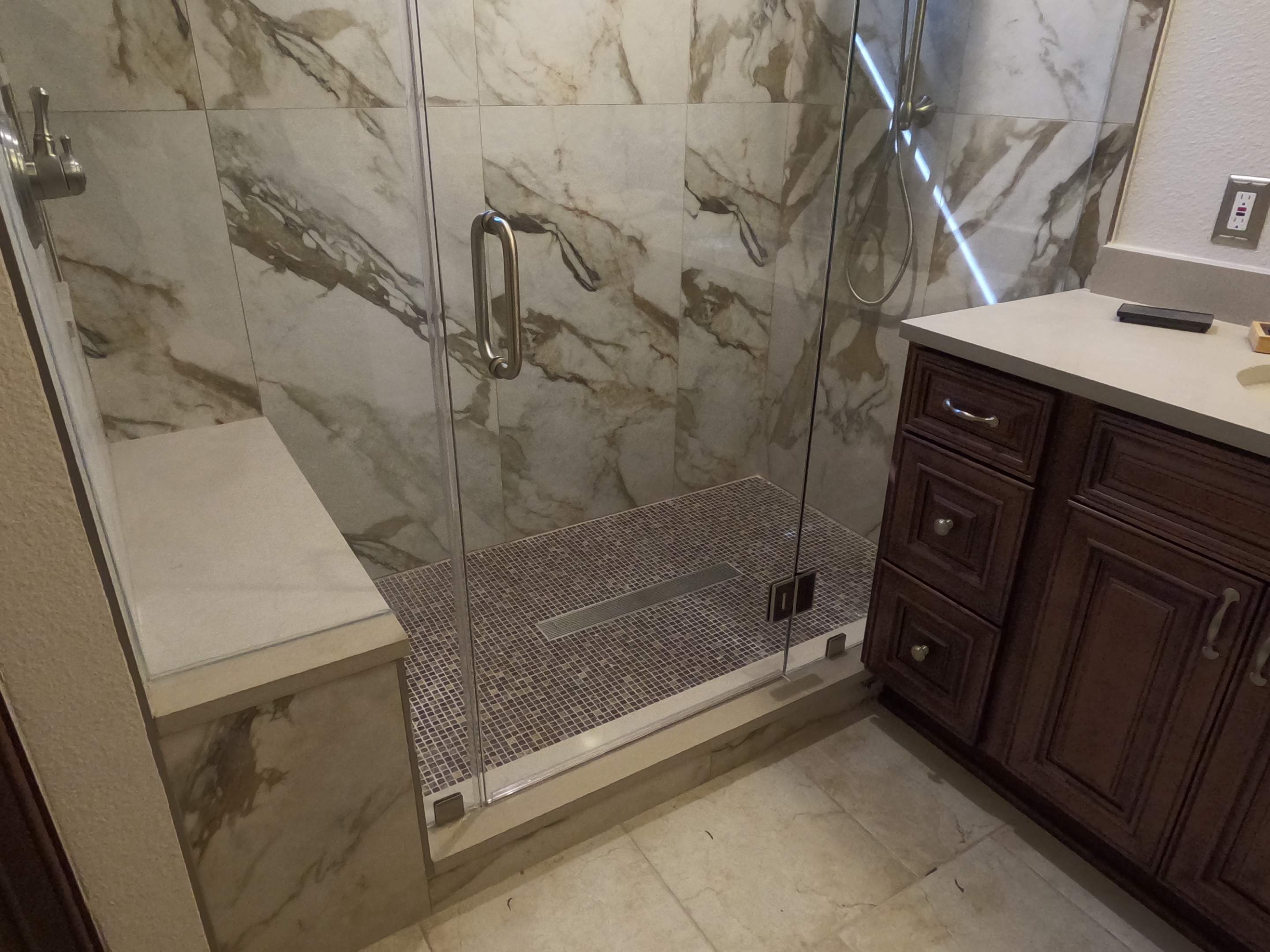 Master Bathroom Renovation Featuring Marble-Look Tile and Quartz Countertops by Mena stone surfaces
