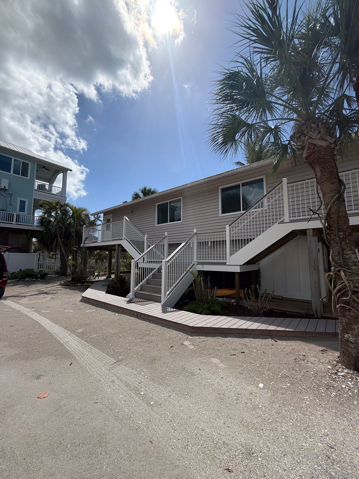 Elevated Coastal Home Renovation with Siding and Custom Decks in Englewood by Smirnov Construction Inc