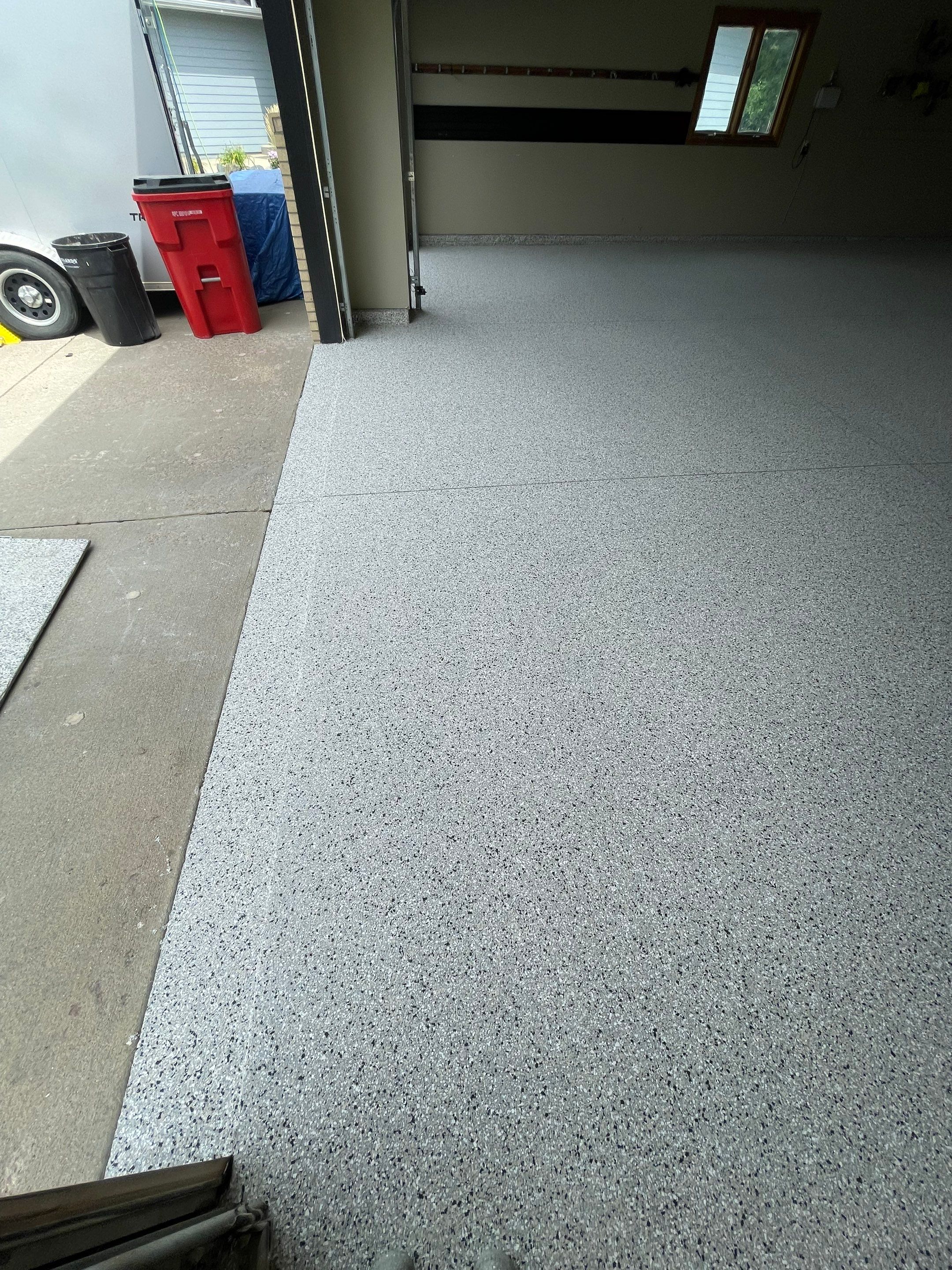 Cabin FEver Flake Garage Floor Coating Installation in Sioux Falls by Select Painting, Coatings & Garage Cabinets
