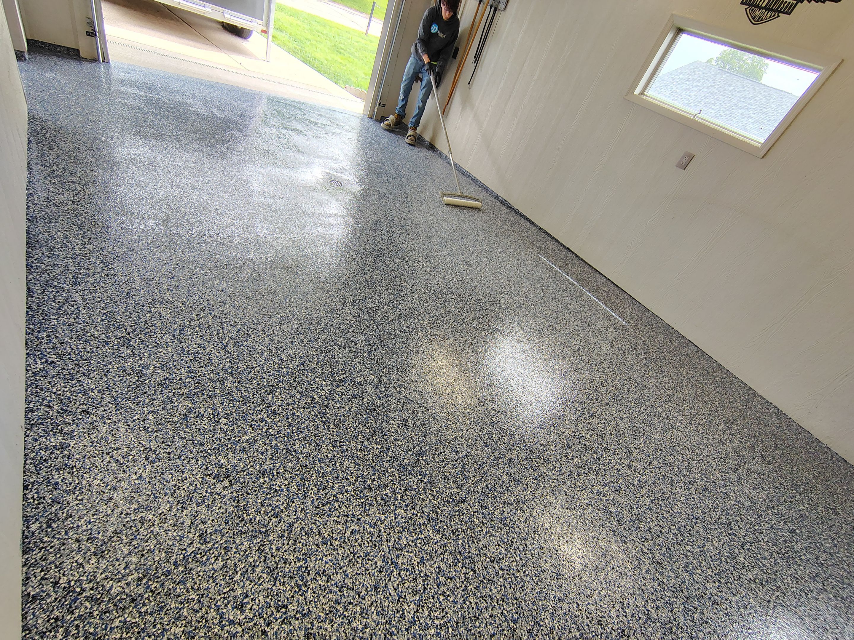 Custom Grey Flake Epoxy Garage Floor Installation in Remsen by Select Painting, Coatings & Garage Cabinets