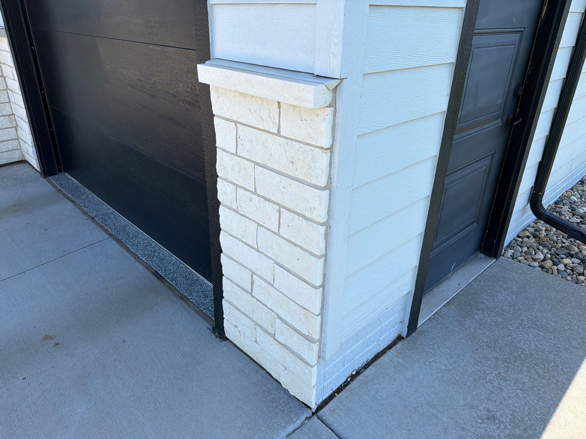 Modern Exterior Update with Siding and Stone Masonry in Sioux Falls by Select Painting, Coatings & Garage Cabinets