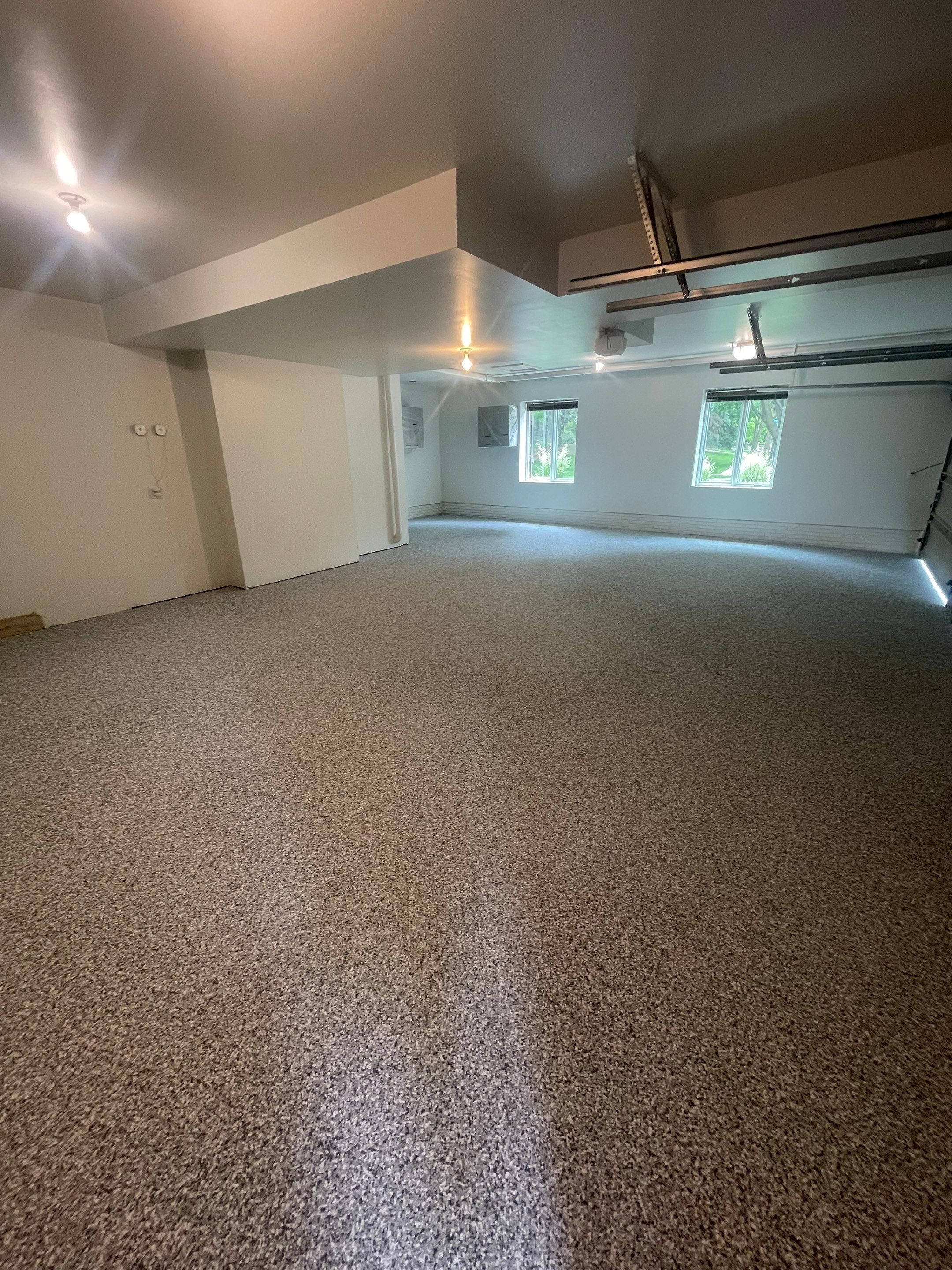 Gray Speckled Epoxy Garage Floor Coating in Sioux Falls by Select Painting, Coatings & Garage Cabinets