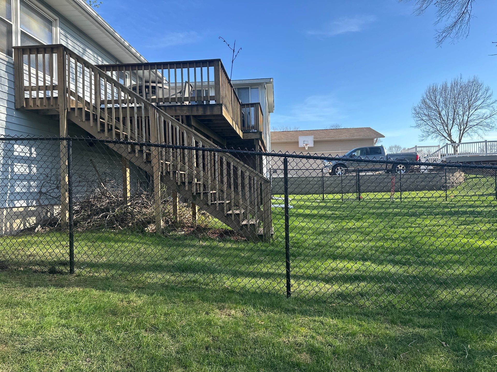 Black Vinyl-Coated Chain Link Fence Installation in Waterloo by Perfect Picket Fence and Stain