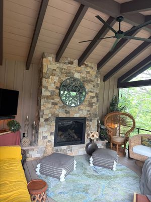 Custom Composite Deck with Stone Fireplace and Modern Cable Railing