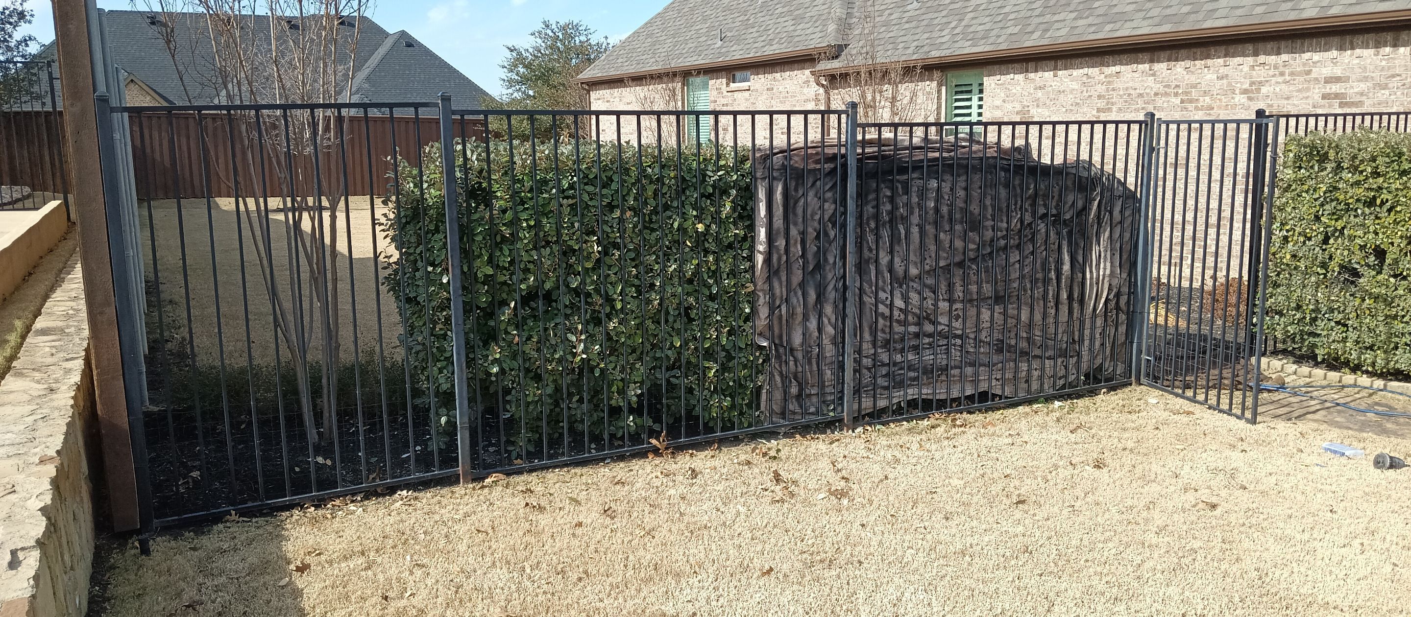 Wrought iron painting using DTM gloss black enamel by Grizzly Fence And Patio