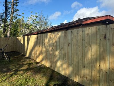Wood Fence Installation using 6Ft Pressure Treated Wood Board On Board Privacy Fence