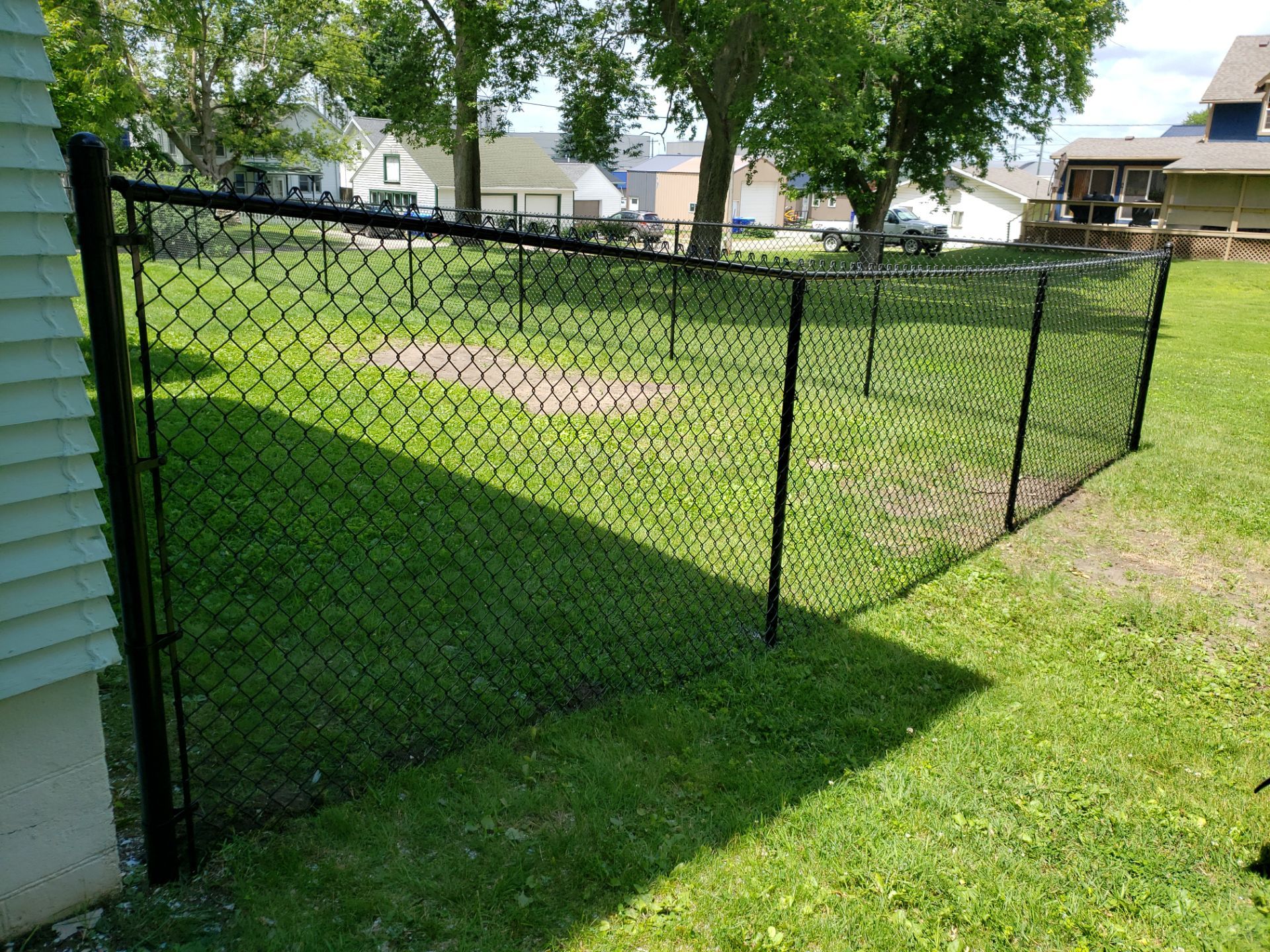 Black Vinyl Coated Chain Link Fence Installation in Independence by Perfect Picket Fence and Stain