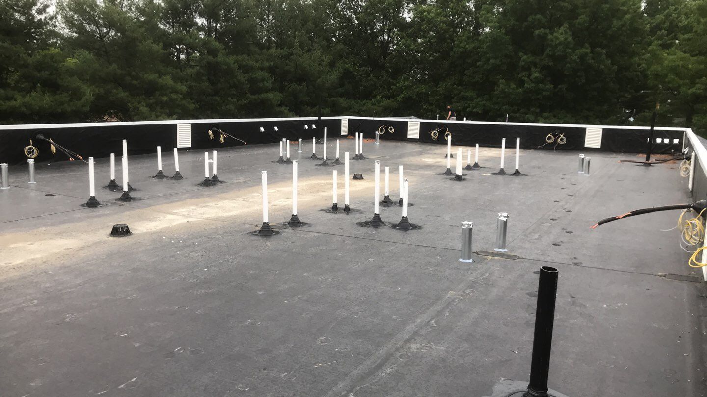 Commercial Roofing Installation using EPDM with white gutters by A Plus Exterior