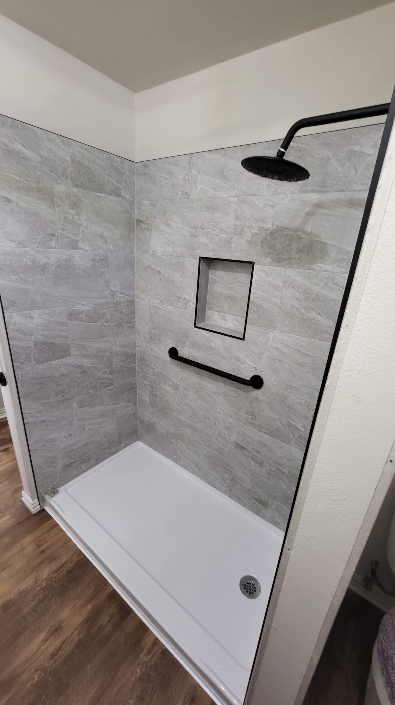 Bathroom Remodel using Tile  by SLM General Contractors & Roofing